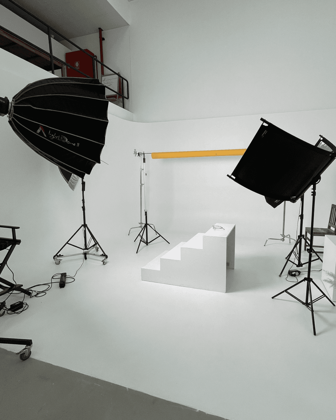 A close-up of a pink cocktail in a martini glass, set against a nighttime background with soft, blurred colors.