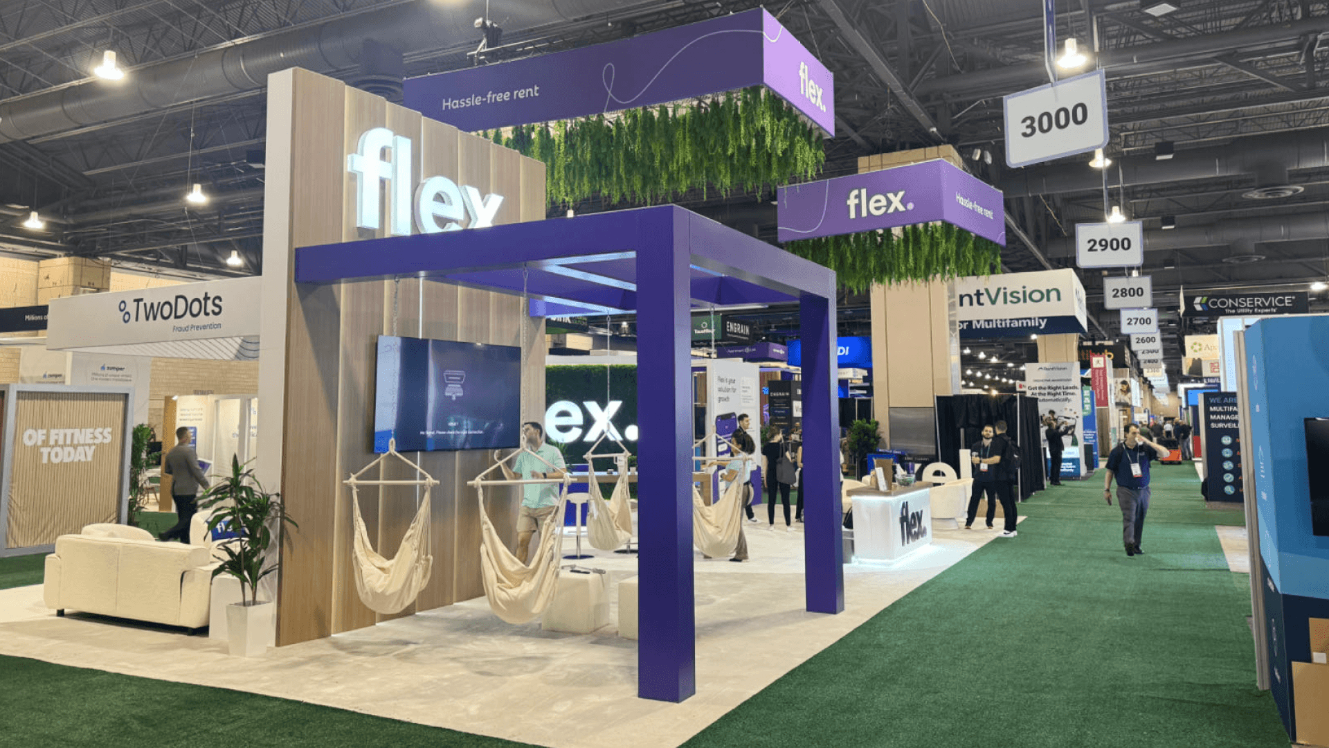 Las Vegas Convention Center booth planning with large island booth, branded graphics, demo counters, meeting area, and show-floor setup