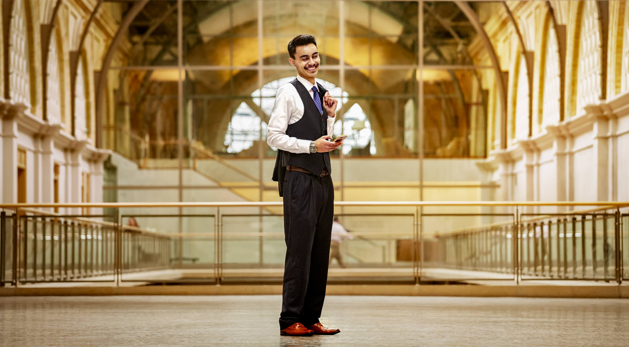 Full-body professional portrait of man in vest and tie at San Francisco ferry building