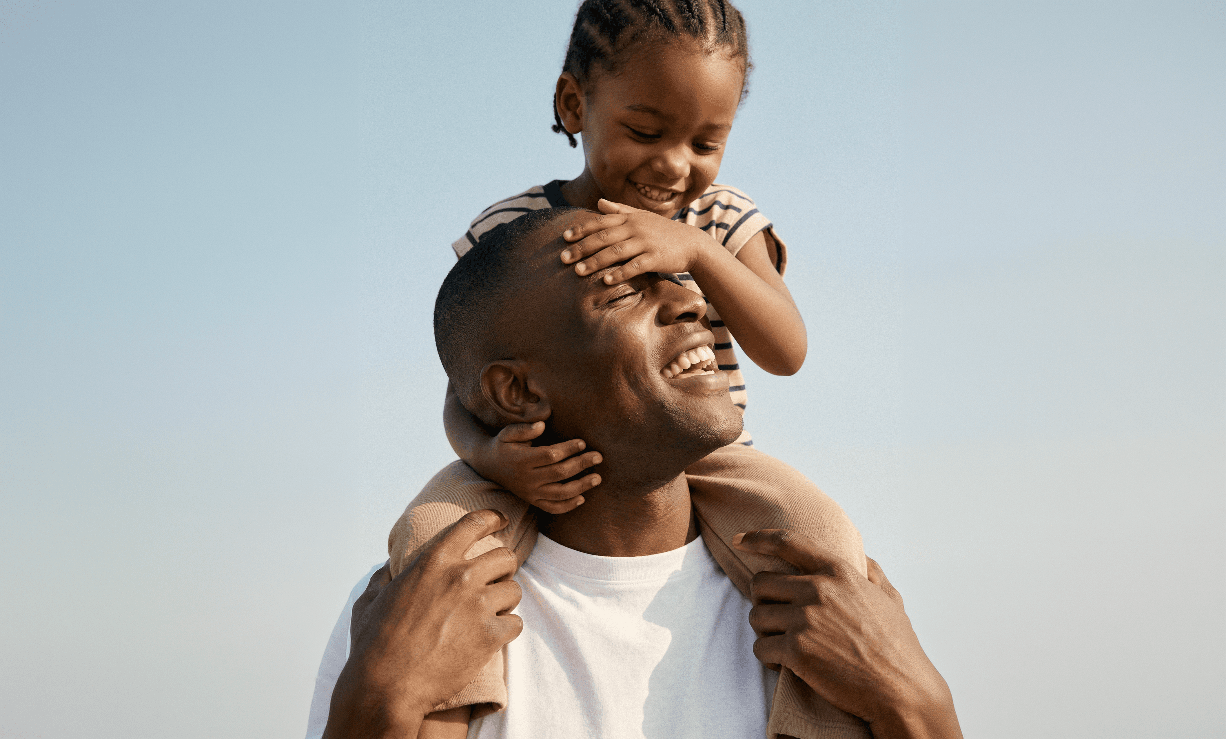 A father carries his child on his shoulders