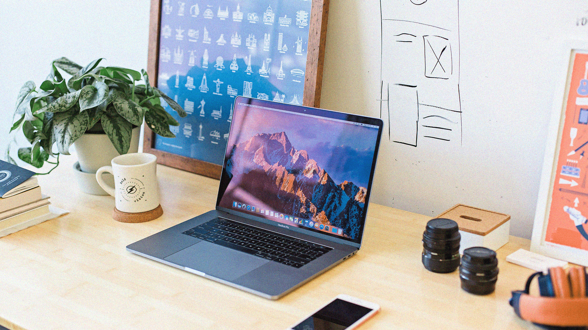 Modern home office setup, keyboard, and indoor plants near a window with blinds.