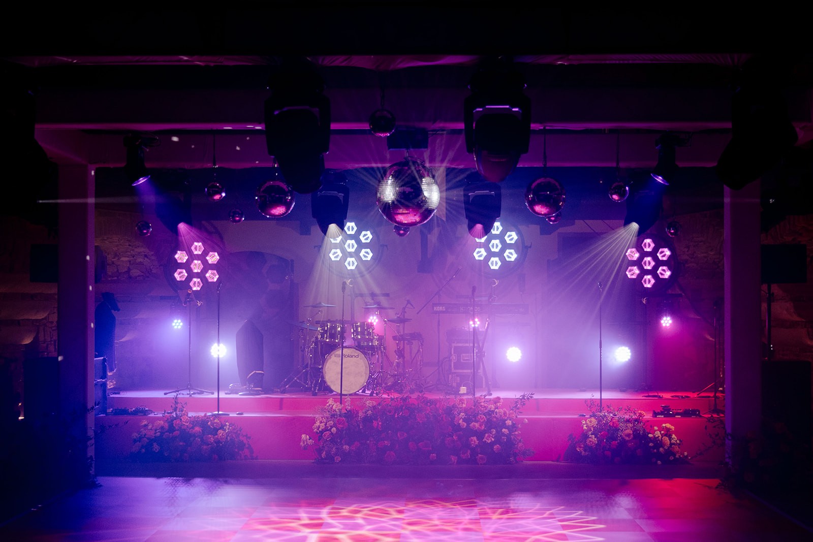 Crowd cheering with green lights at concert