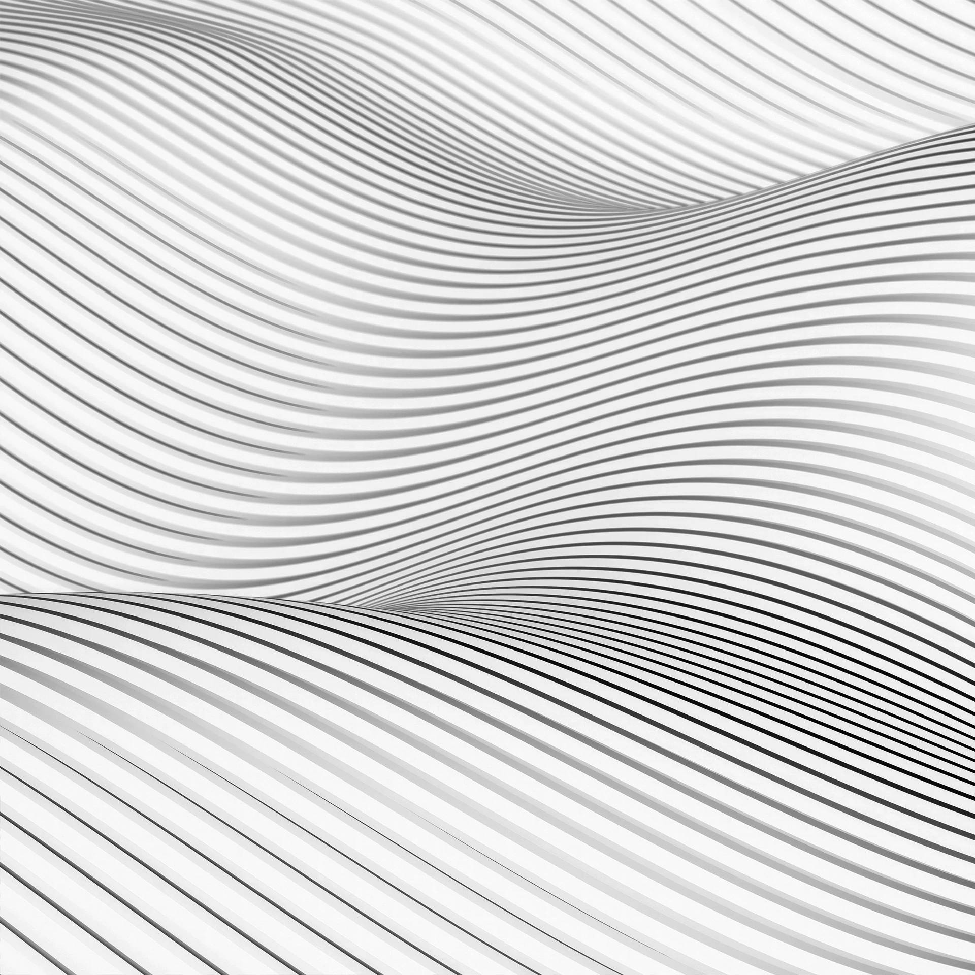 Abstract flowing waves in grayscale creating a smooth, undulating pattern with light and shadow gradients