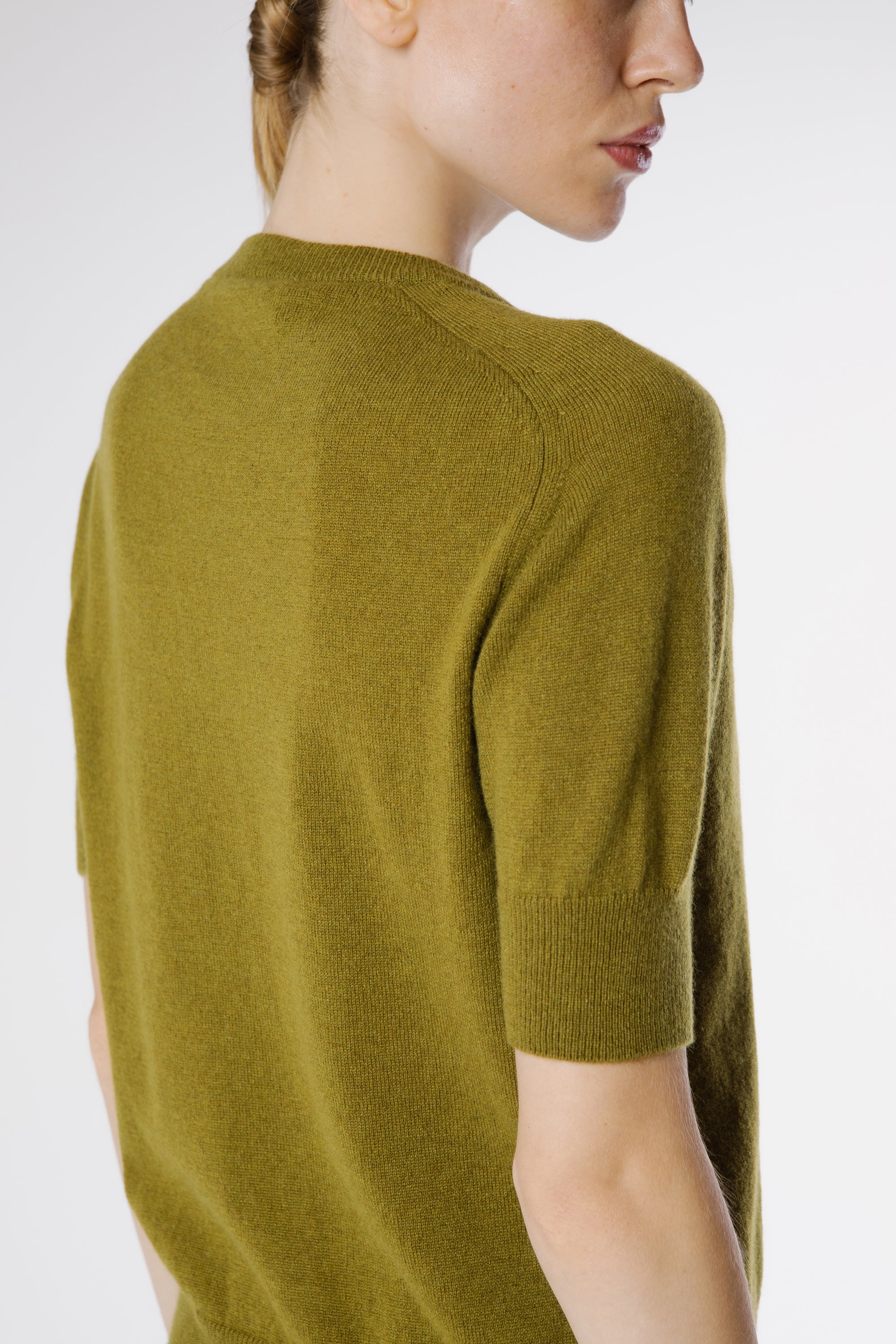 Back view of the Magda Cashmere Pullover Juniper showcasing its smooth pure cashmere texture and timeless minimalist cut.