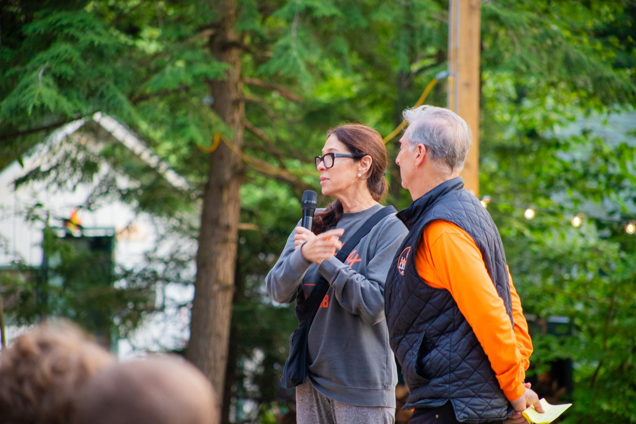 Stephanie and Rich Moss speaking to camp at an evening gathering