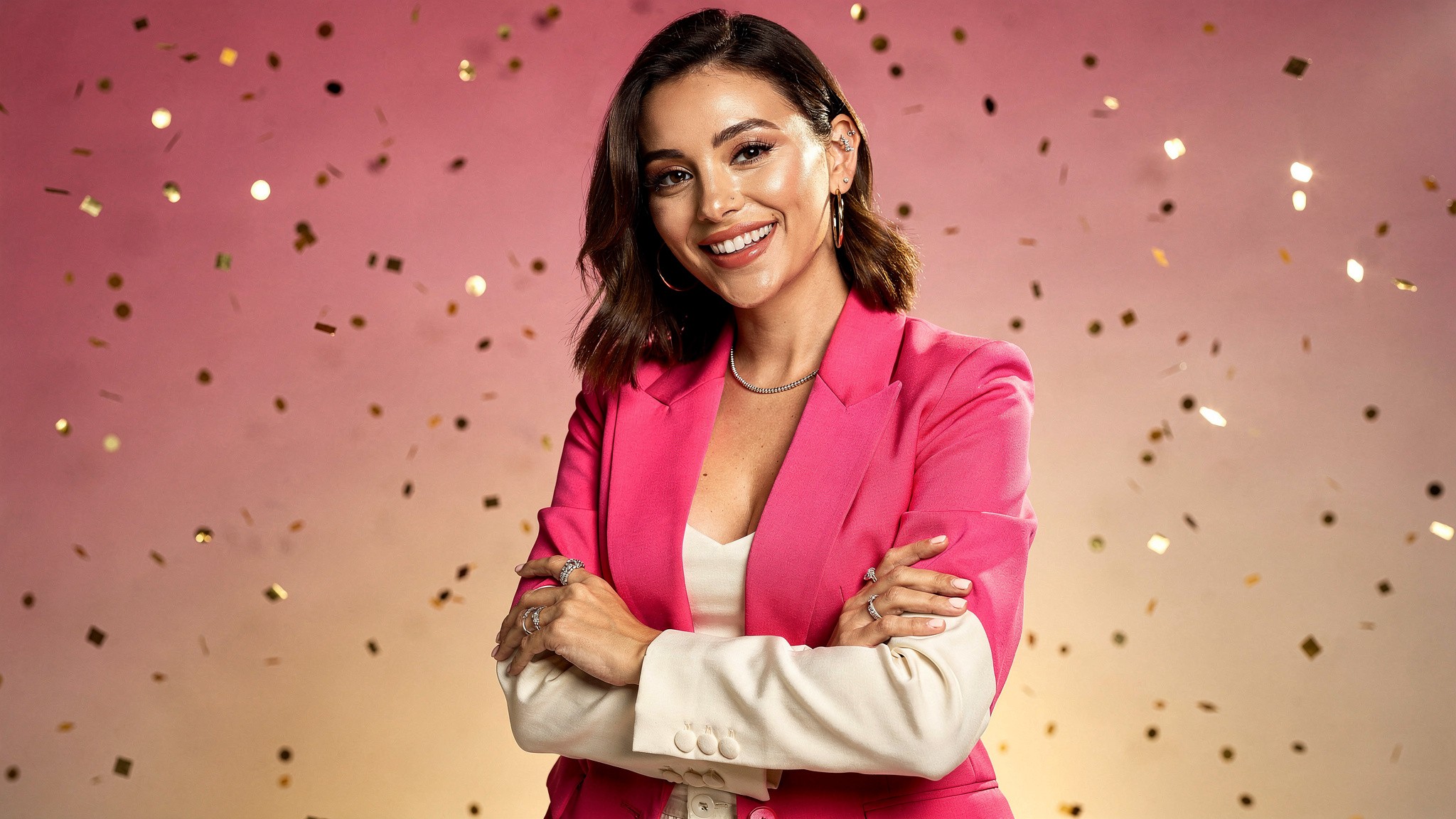 Confident creator with arms crossed smiling, sense of momentum and growth
