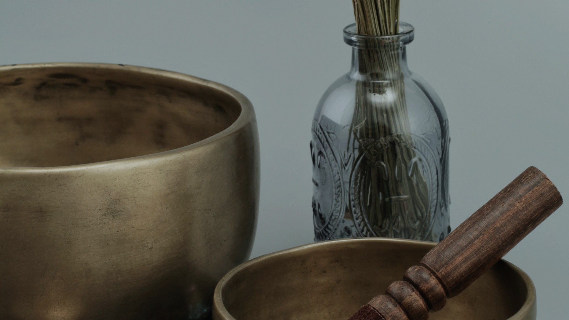 a black and white cat laying on top of a white wall