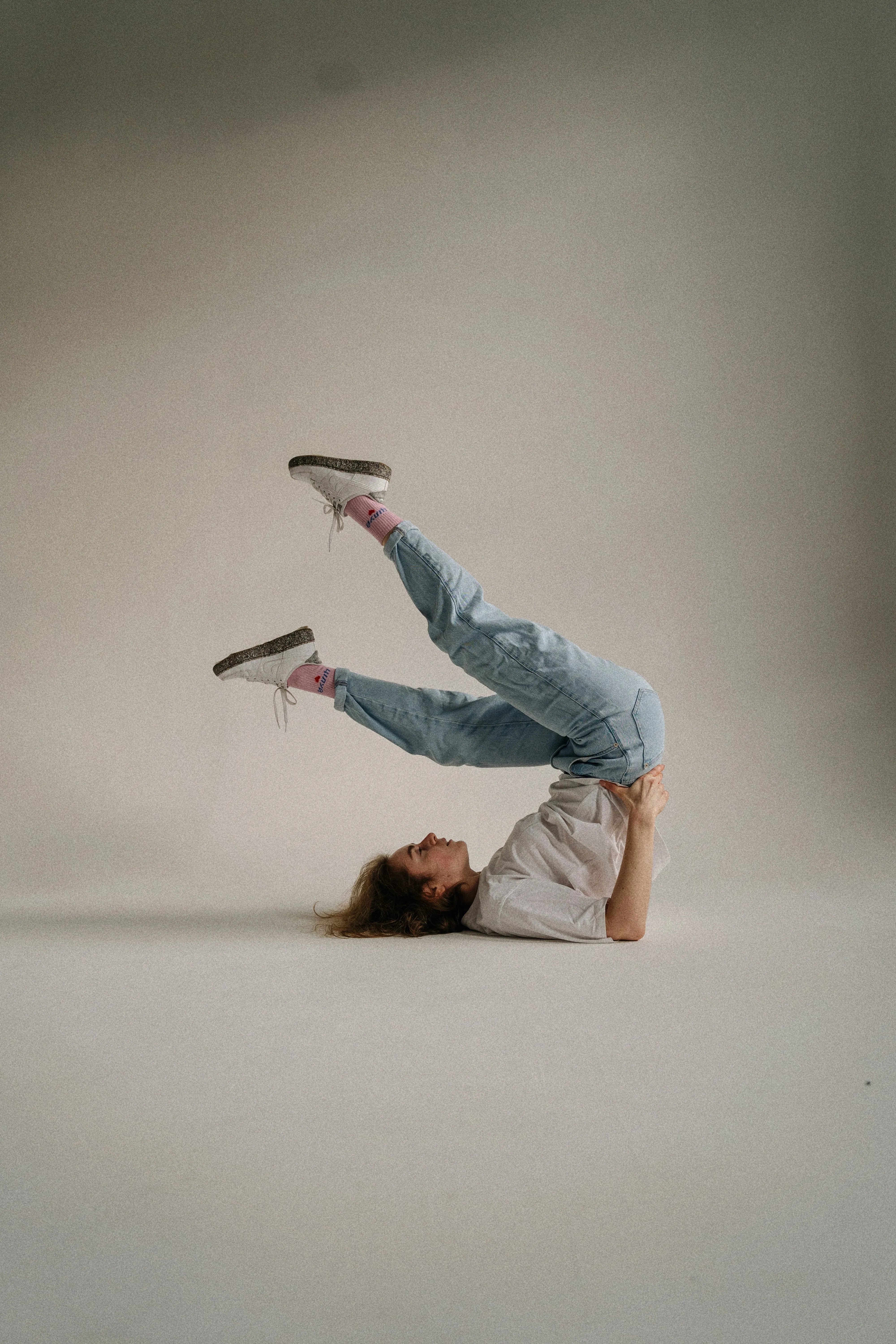 a woman is doing a handstand on her feet