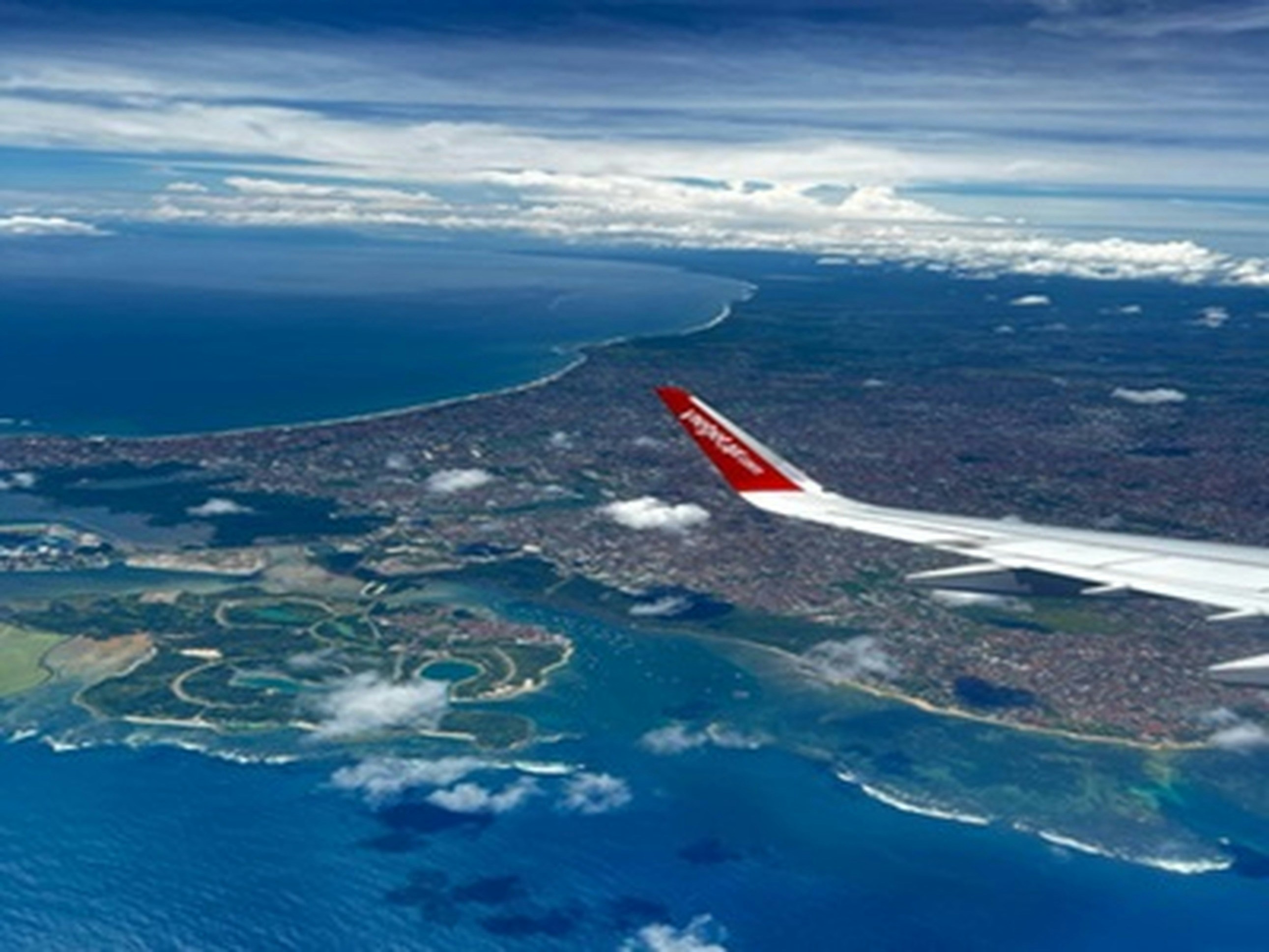 an airplane flying over a large body of water