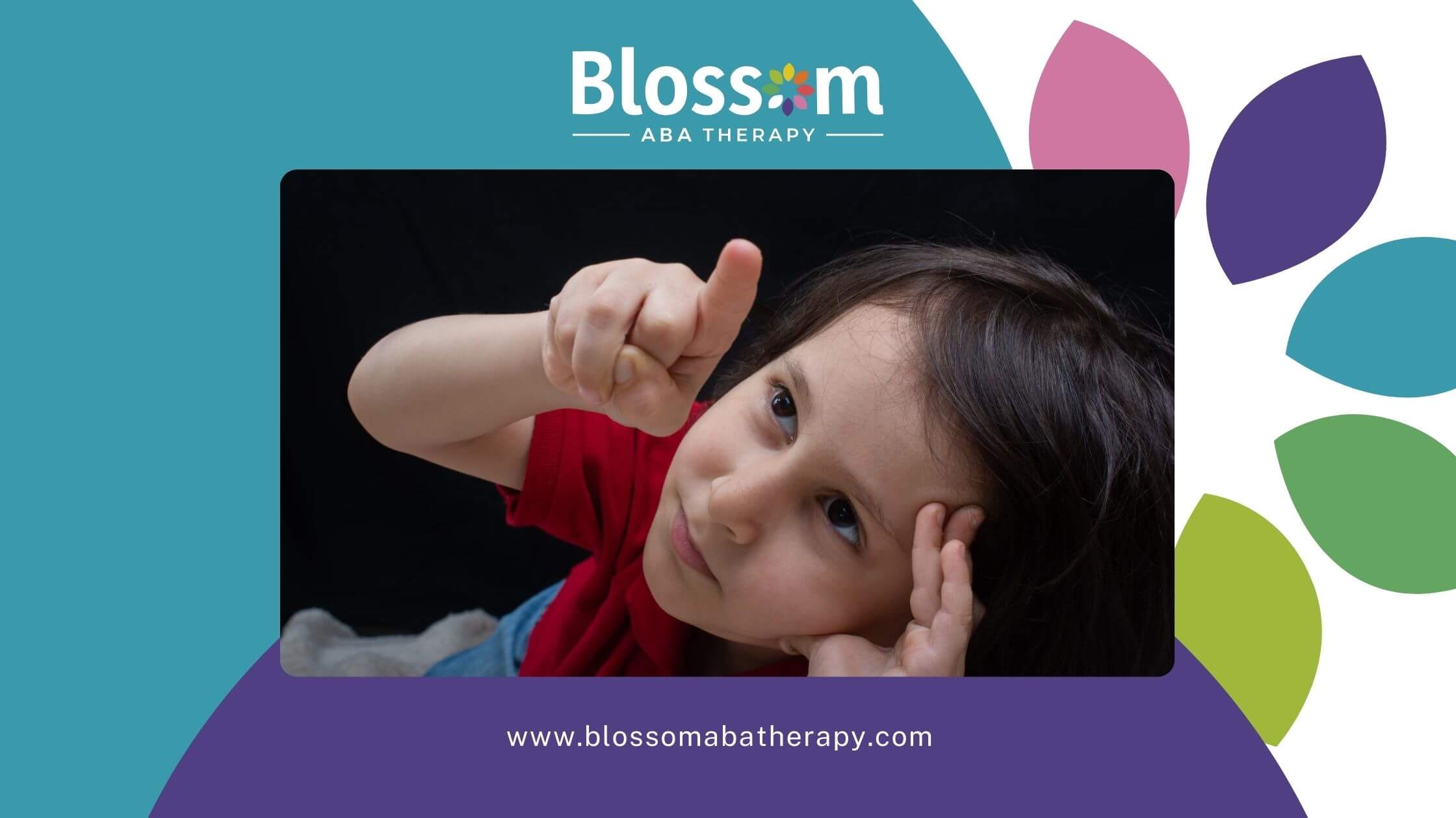 Close-up of a young child with autism pointing upward while looking attentively.