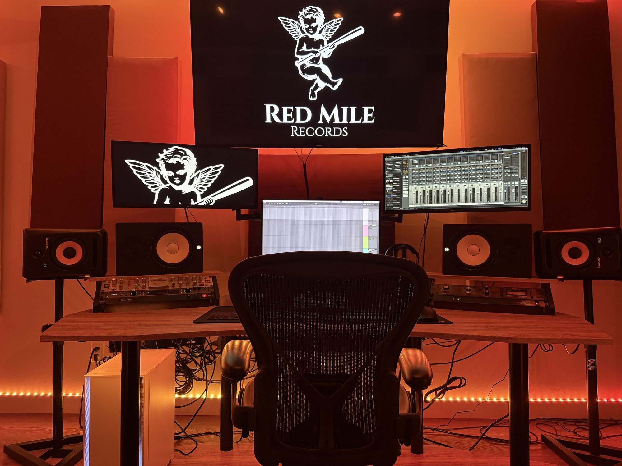 Professional audio engineering desk with studio monitors and mixing software at a Calgary music production studio.