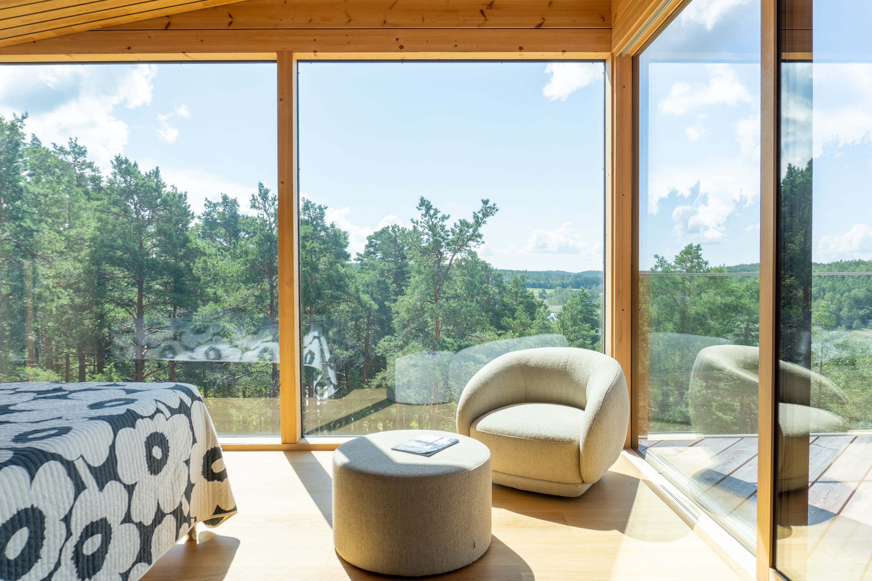 Bedroom with large windows and a corner seat