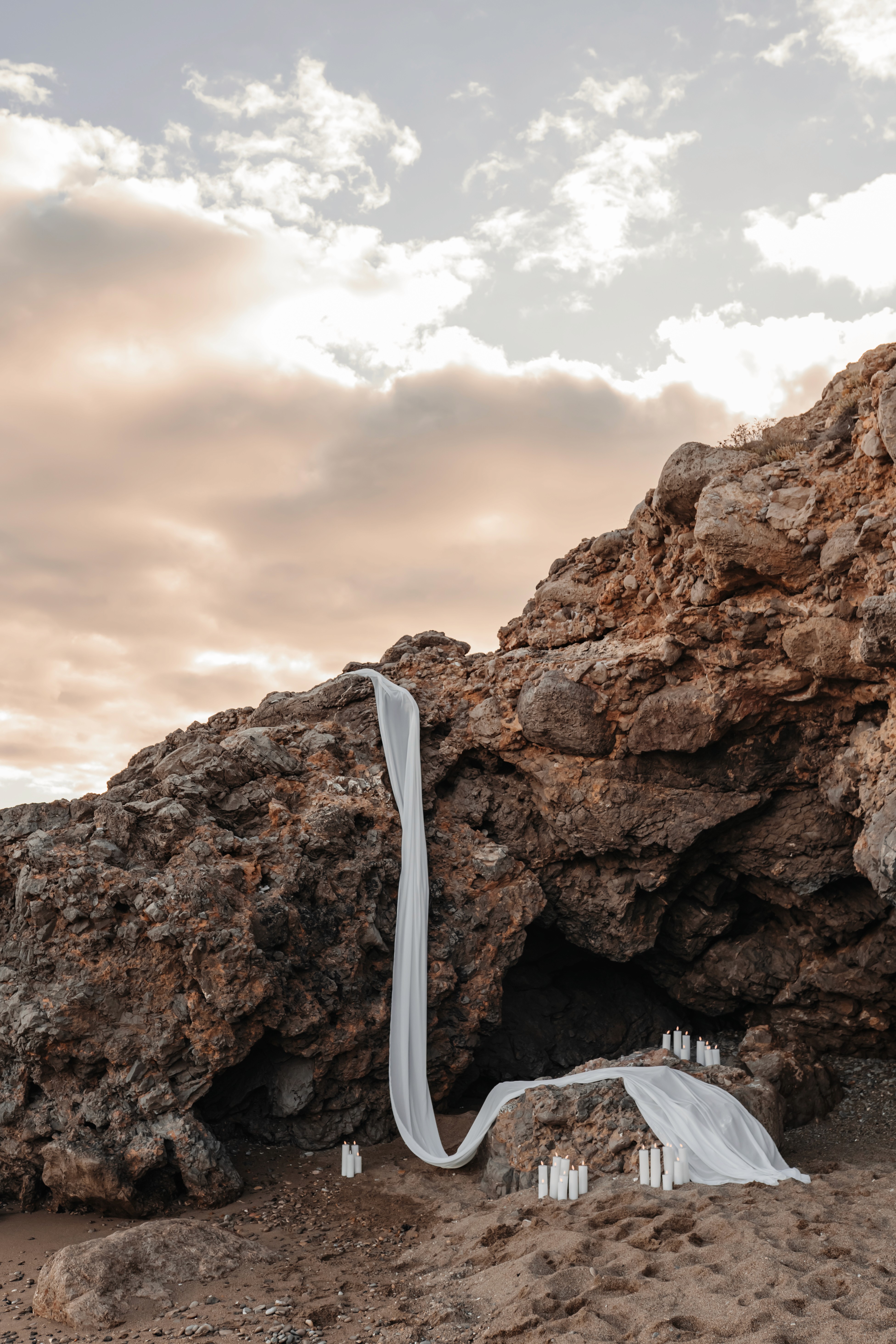 A vibrant bridal bouquet featuring a mix of red, pink, and purple flowers.