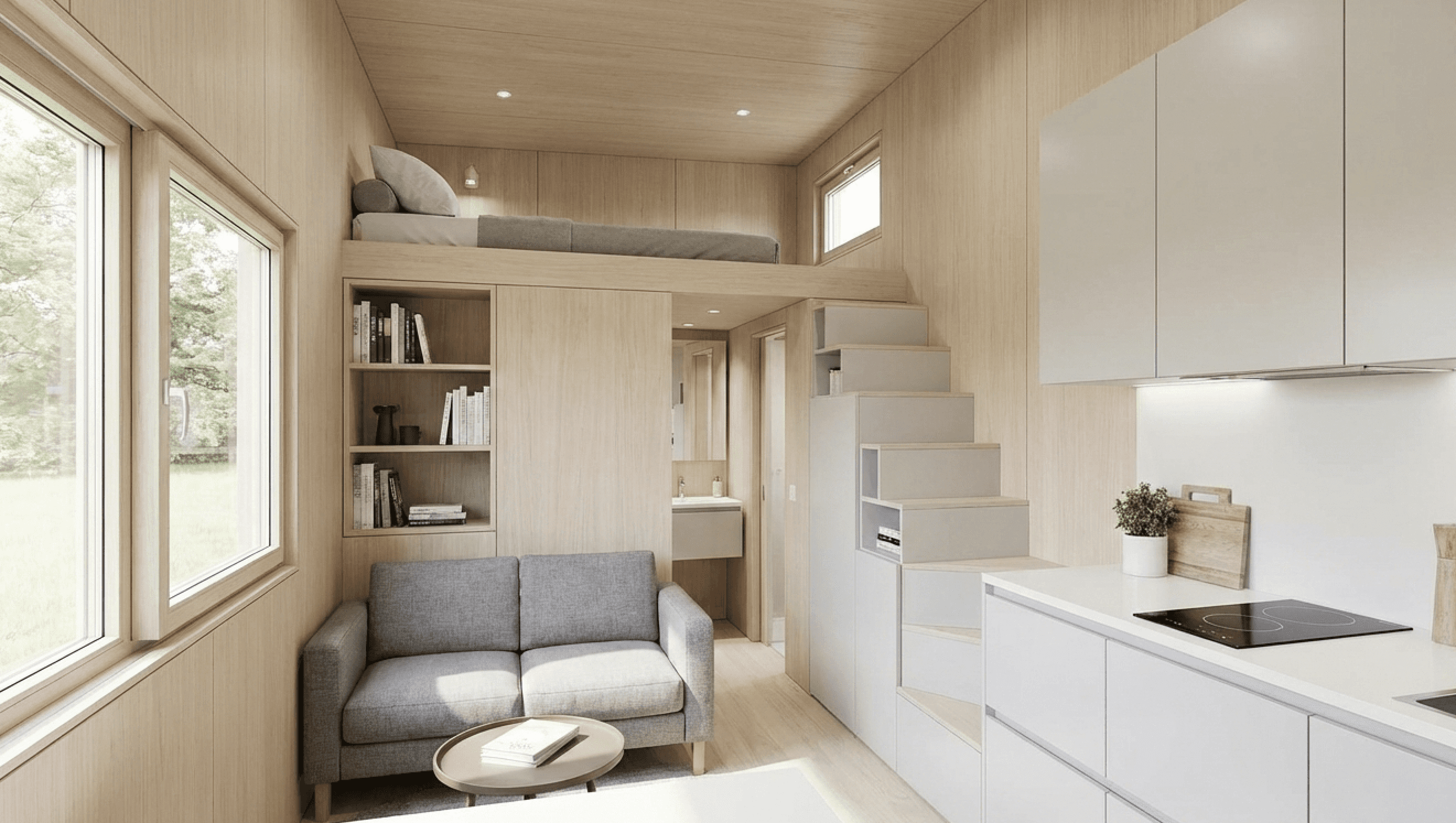 Tiny home open-concept interior with lofted bedroom, built-in storage stairs, and compact kitchen