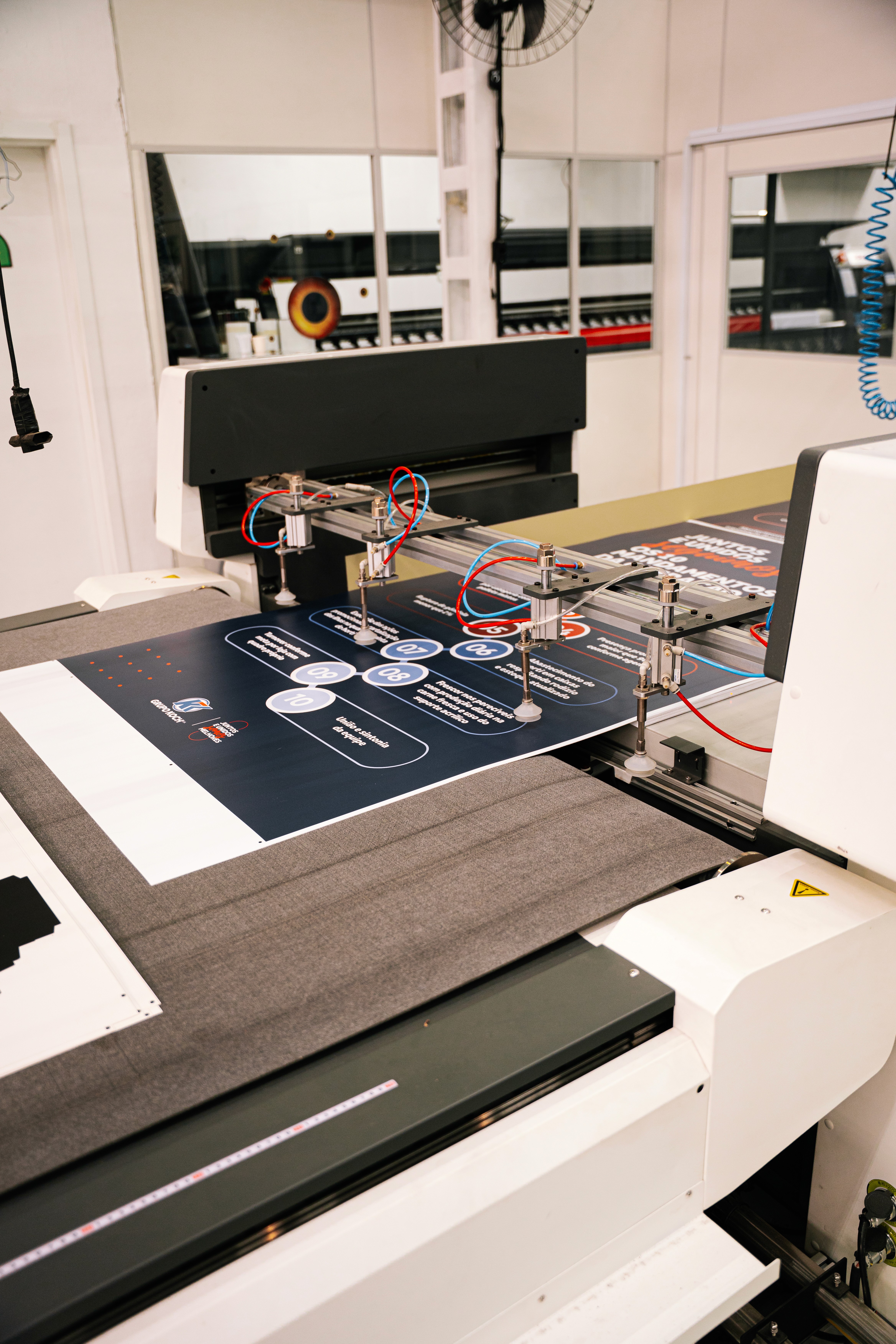 Four diverse professionals collaboratively working on a laptop, with one person pointing at the screen while others observe.