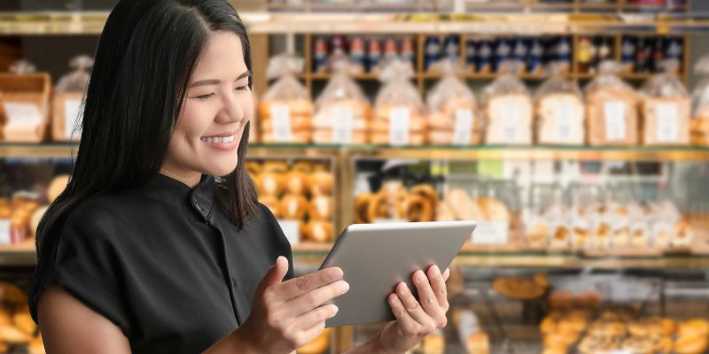 A Malaysian business owner with a tablet in her restaurant