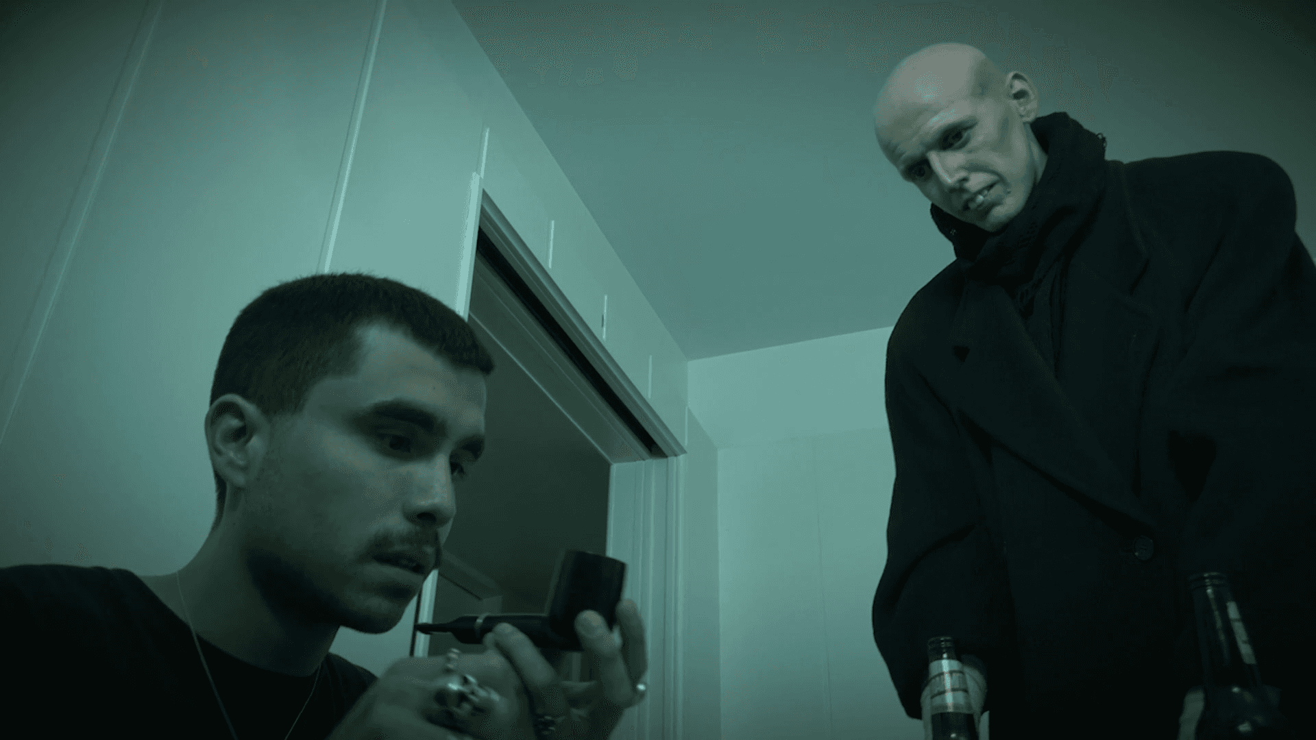 View of the French countryside through a stone villa’s open living room, with sofas and trees framing the scene