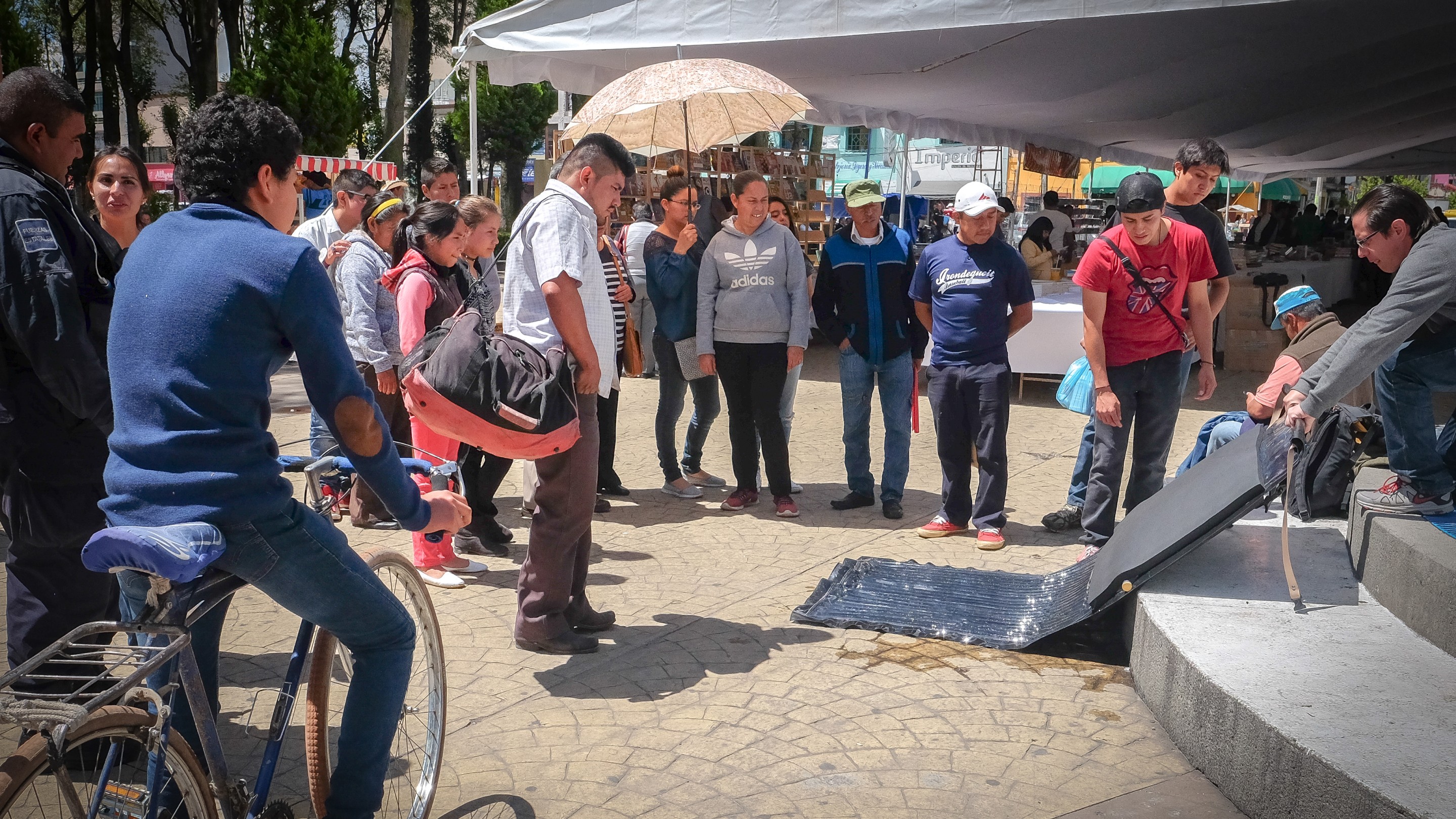 People in village gathered to look at Sun Tap prototype.