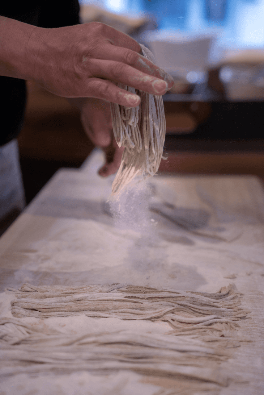 Soba noodles being dusted from the flour