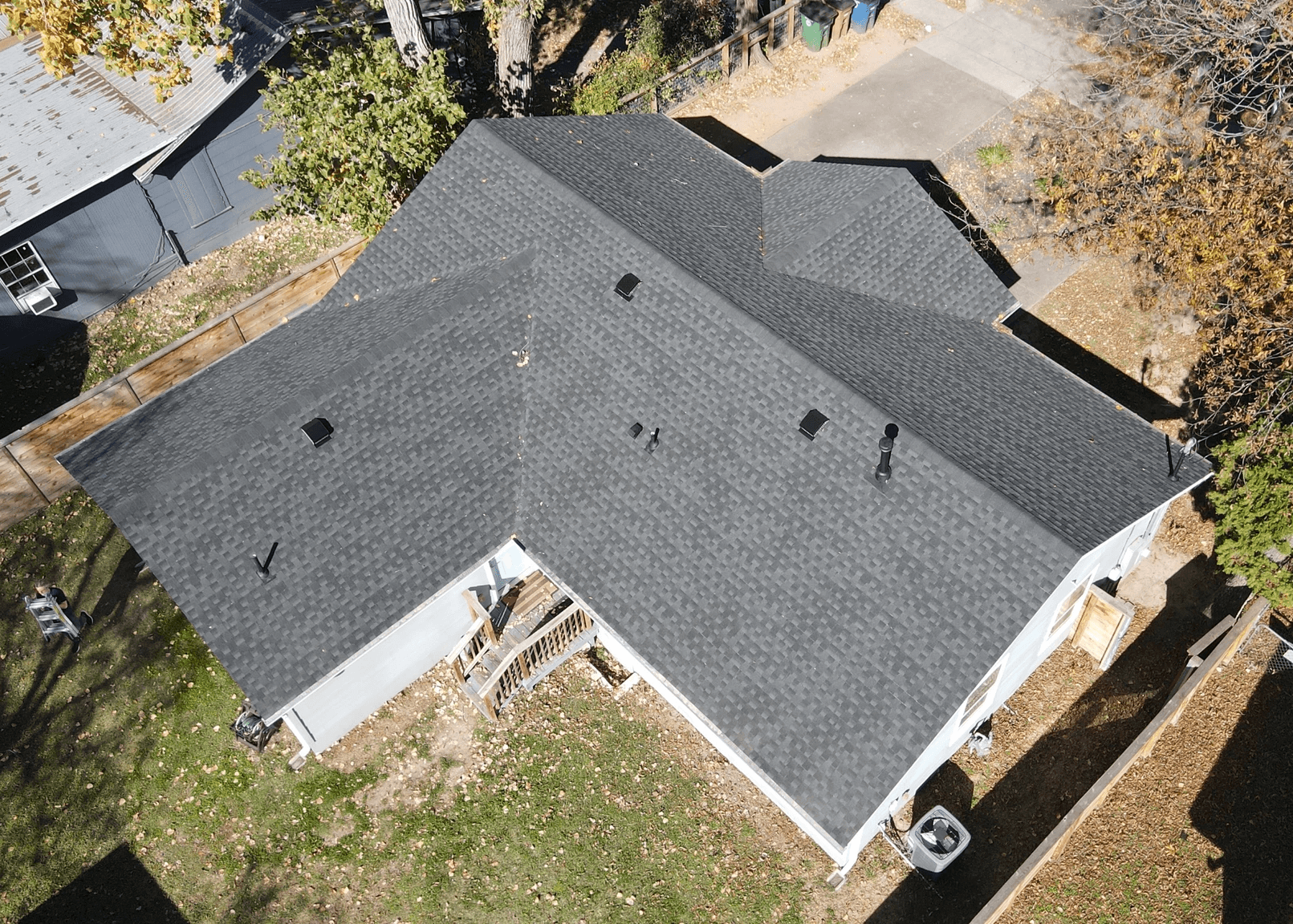 Pewter grey crossed hip roof with GAF HDZ architectural shingles and slant-back vents, combining a sophisticated design with effective ventilation.