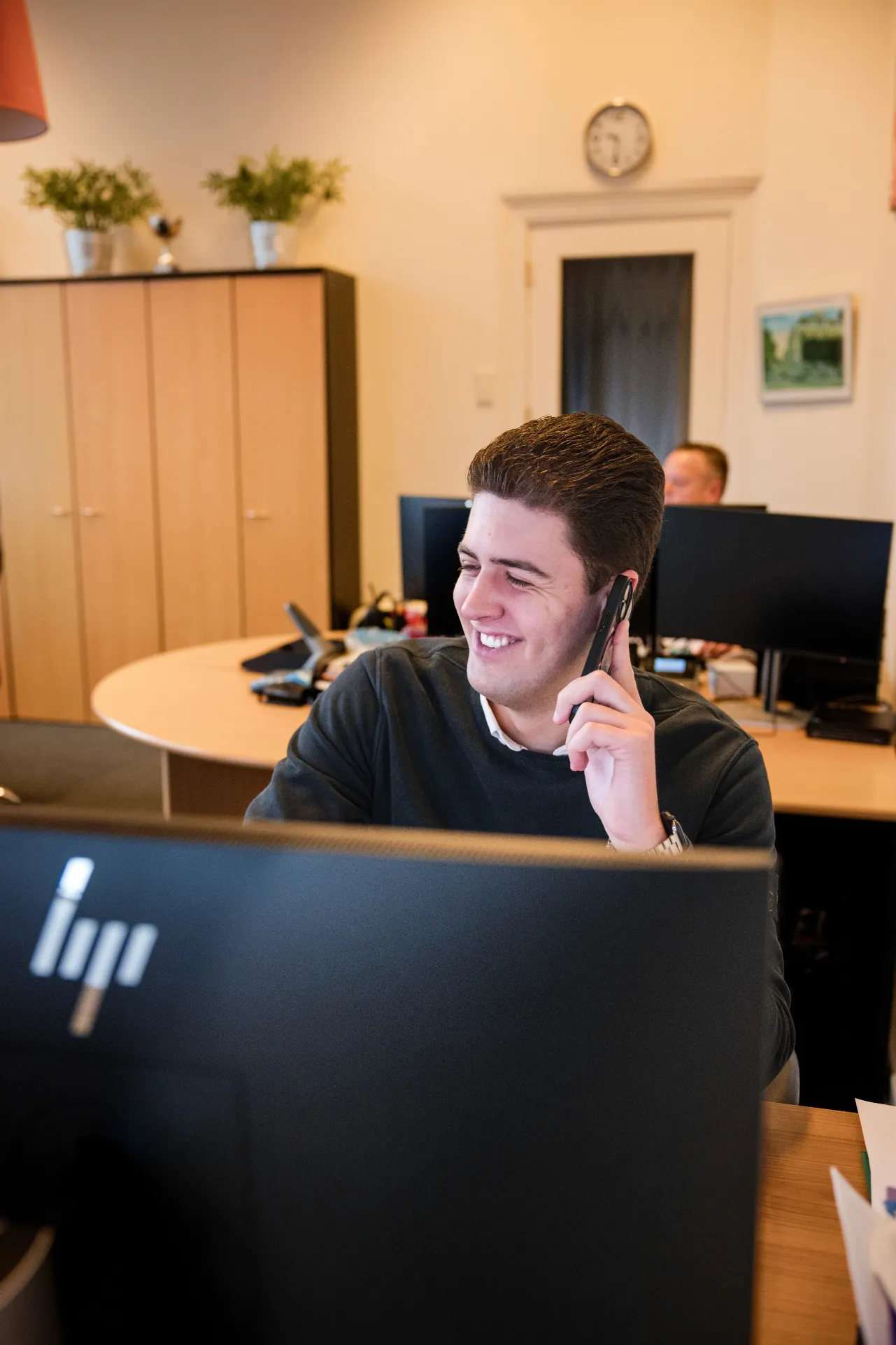 man in green and black plaid long sleeve shirt holding red and black cordless hand drill