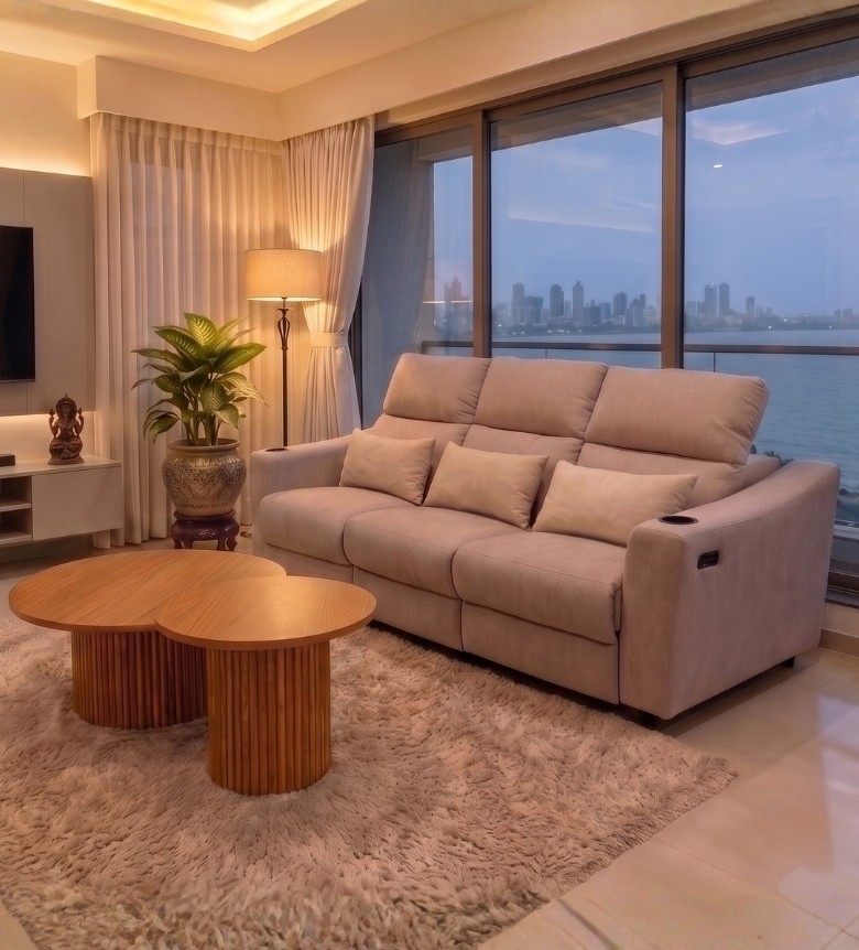 Three‑seater cream upholstered sofa with tufted back cushions and wooden arm frame