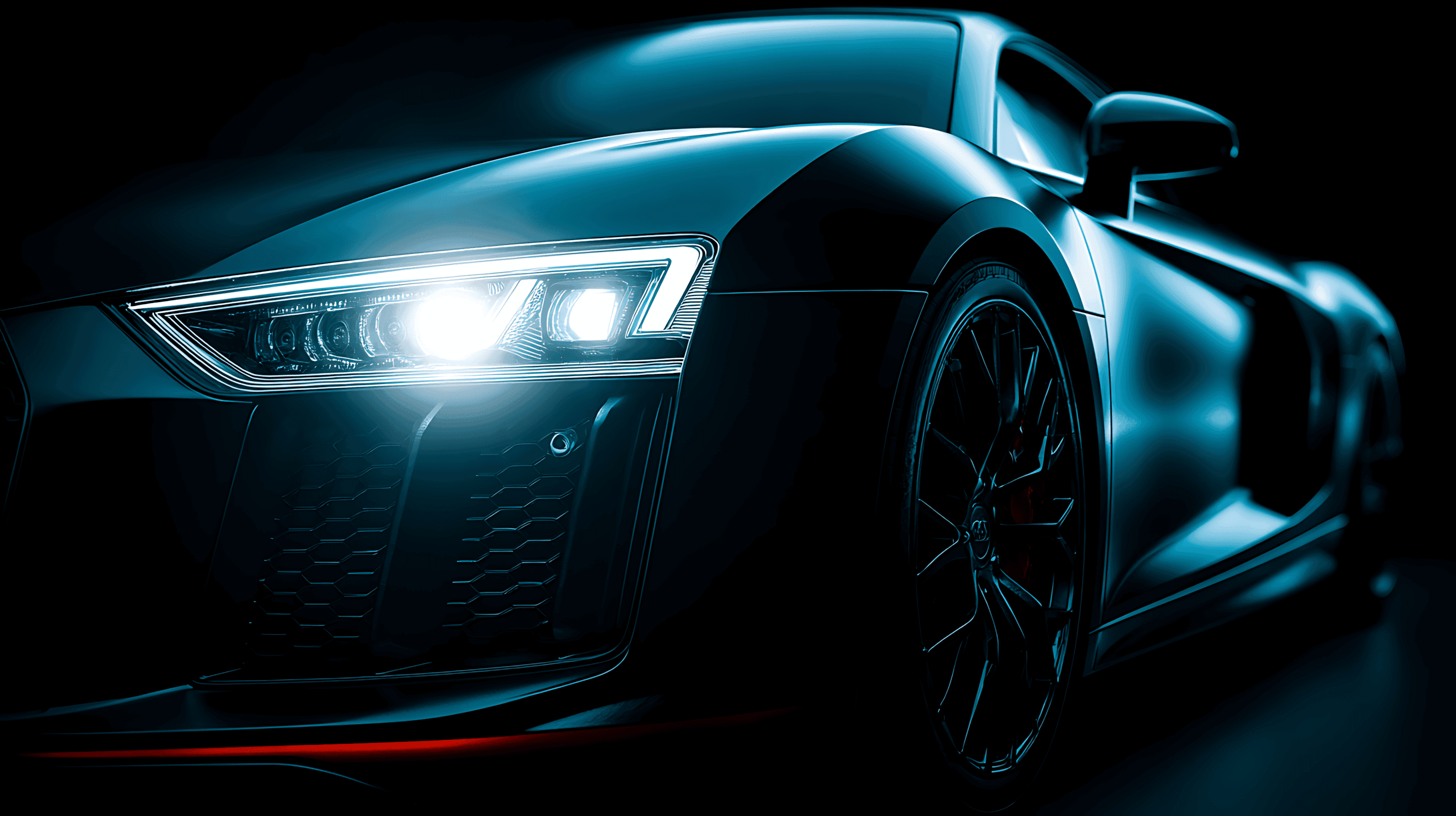 A close-up, low-light shot of a high-performance sports car's front end, with its headlights brightly illuminated