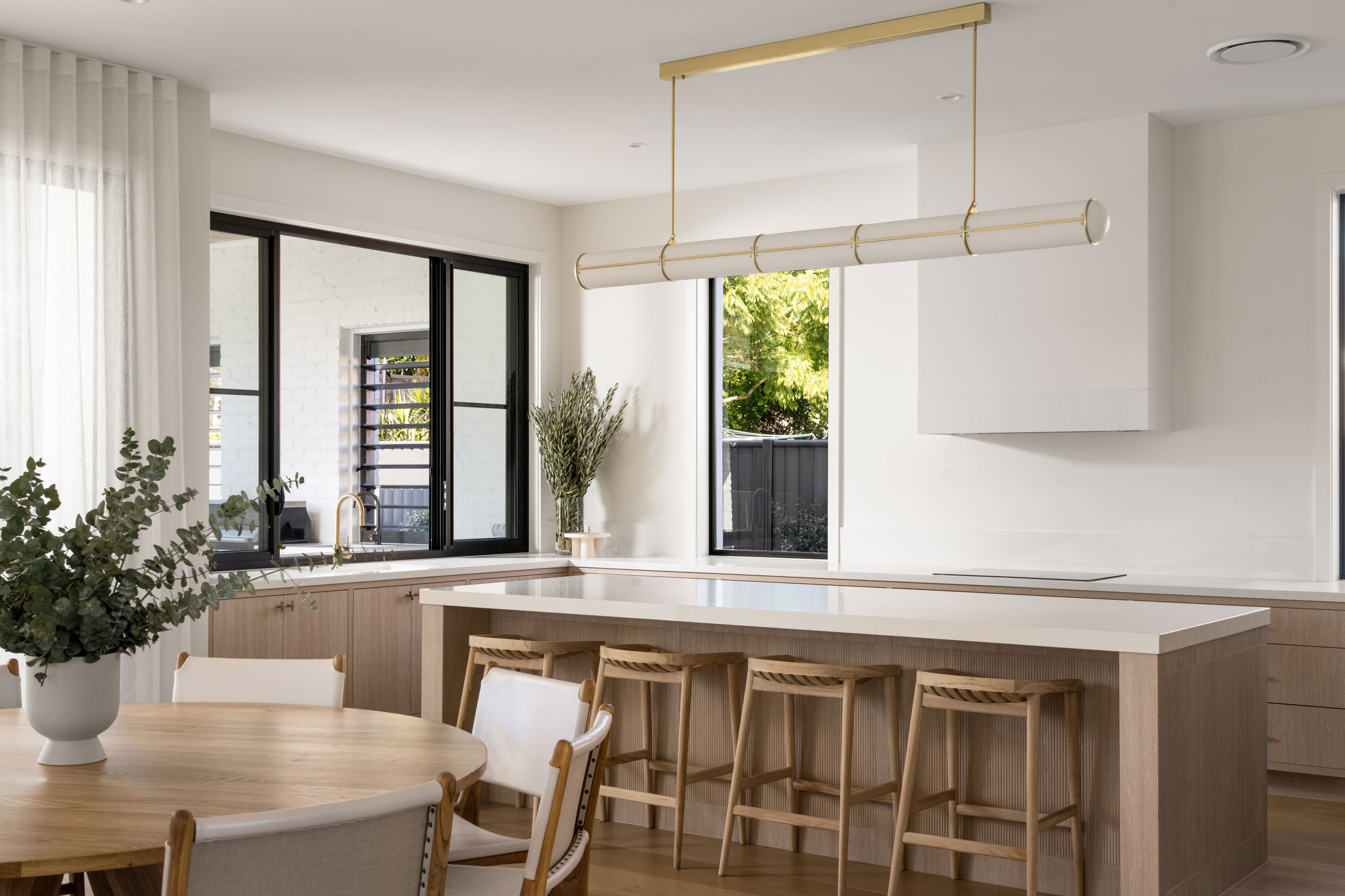 Modern kitchen design with large picture window overlooking backyard