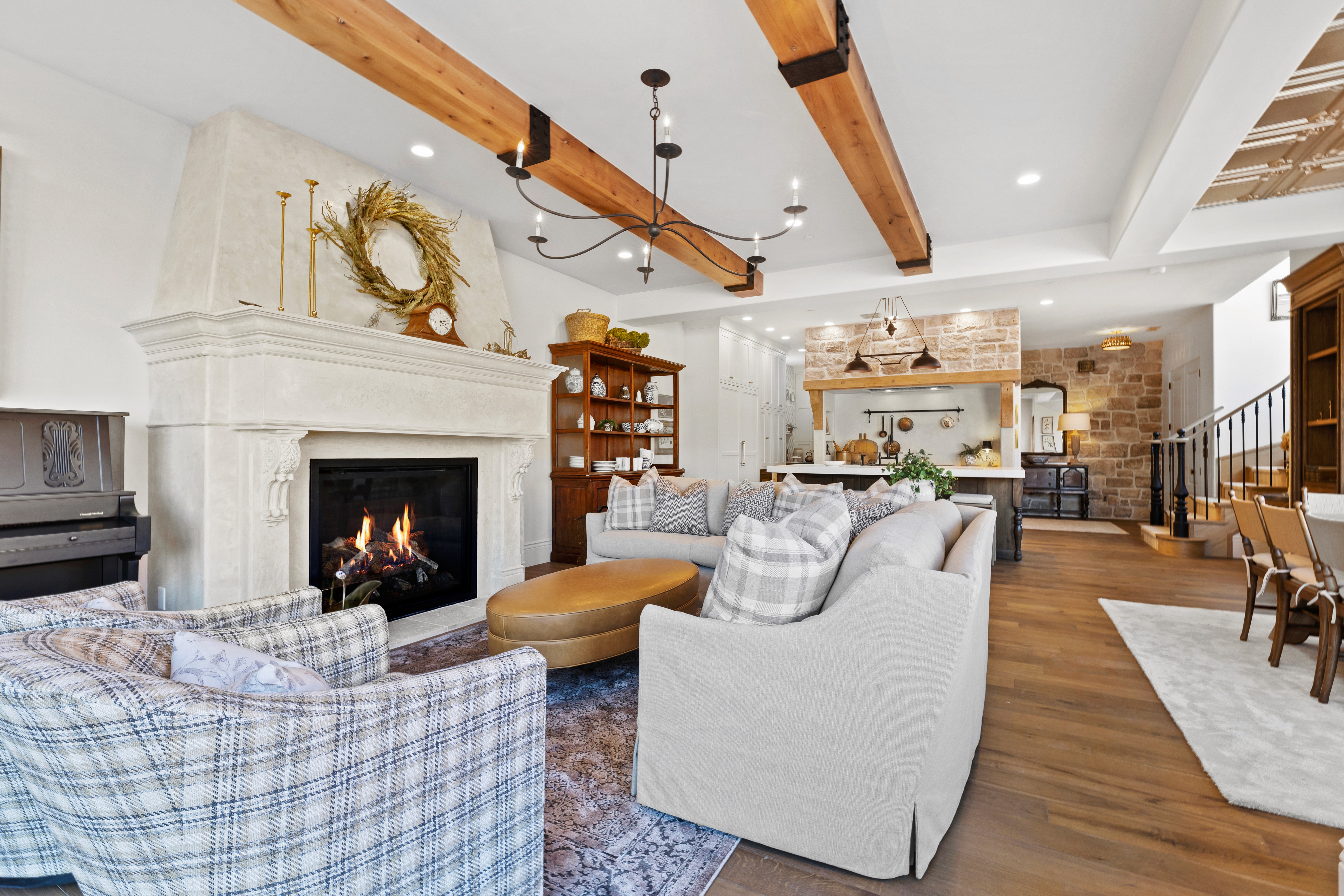 Living room in a custom home in Rockville, Utah with wood beam accents and a custom cast fireplace.
