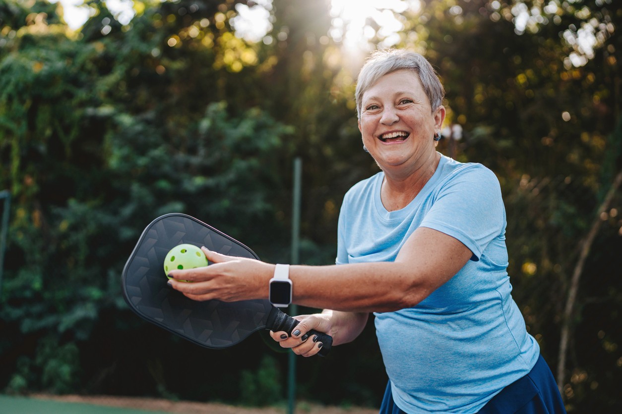 Active adult woman playing pickleball