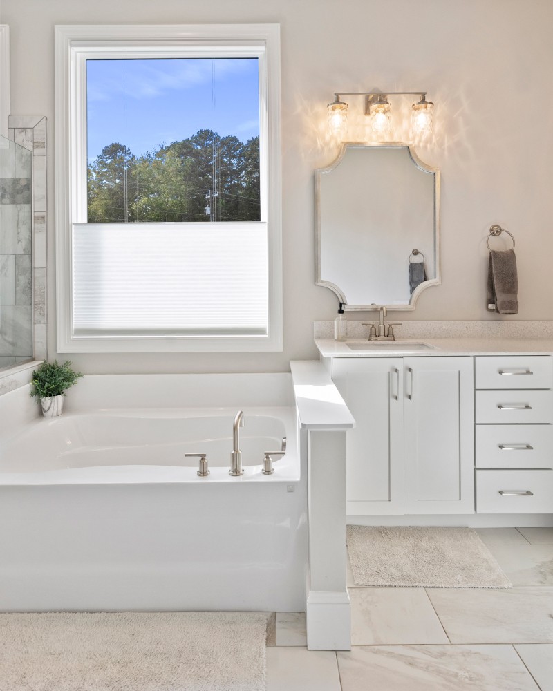 Close-up of a dark green leaf showing its textured surface and central vein against a muted background.