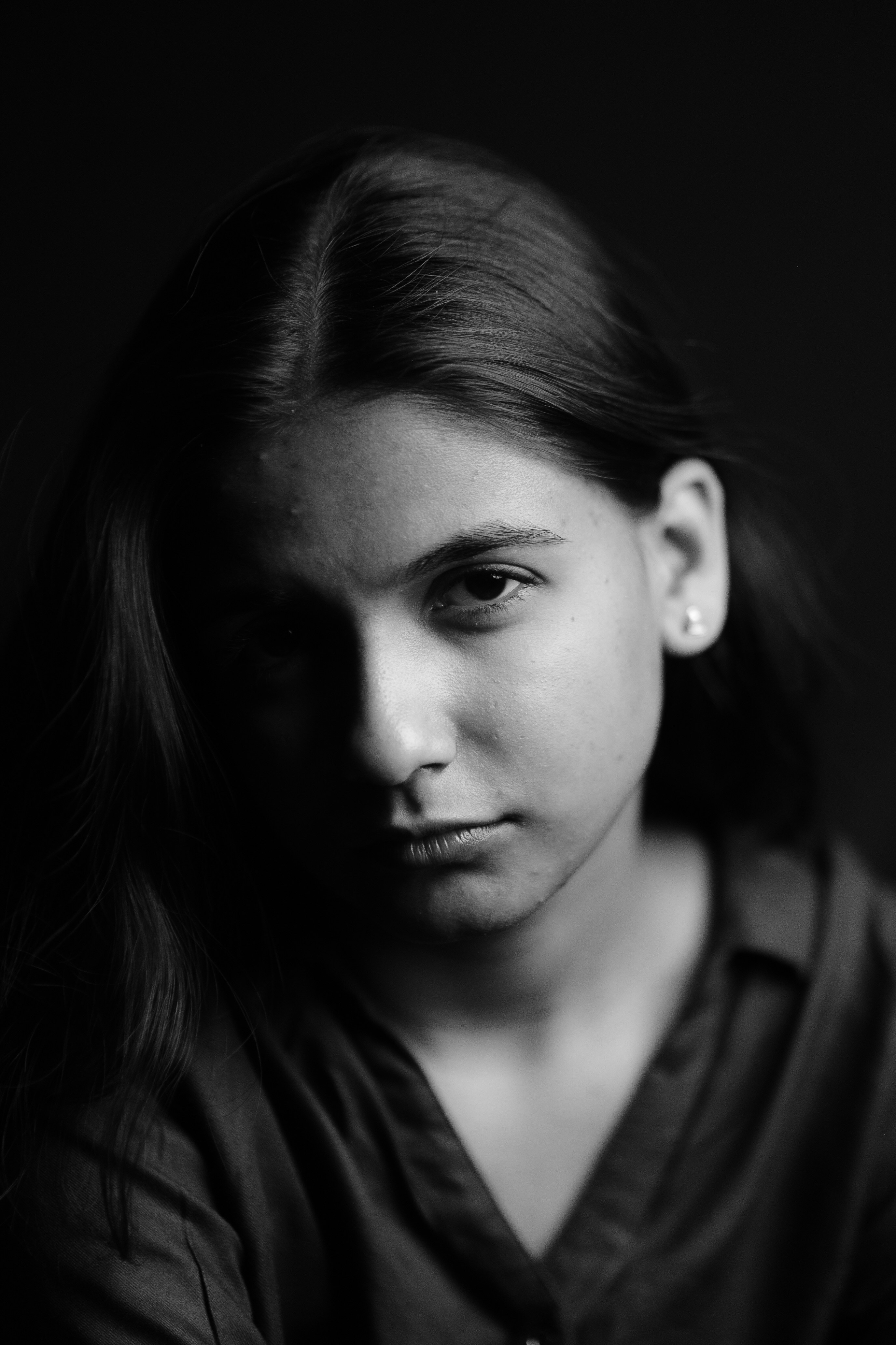 A woman with long hair is looking at the camera