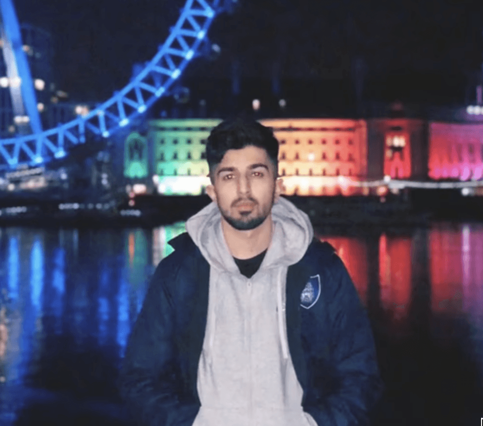 A man works on a laptop in an office.