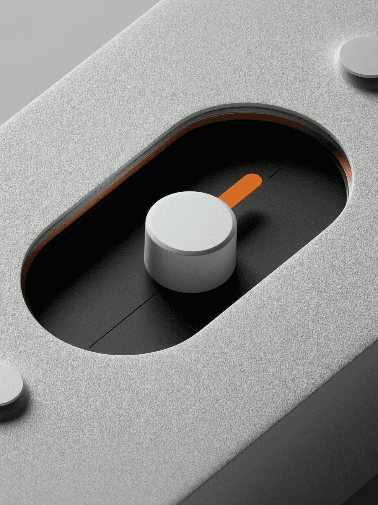 Close up of metal slot control with round knob and orange slider detail