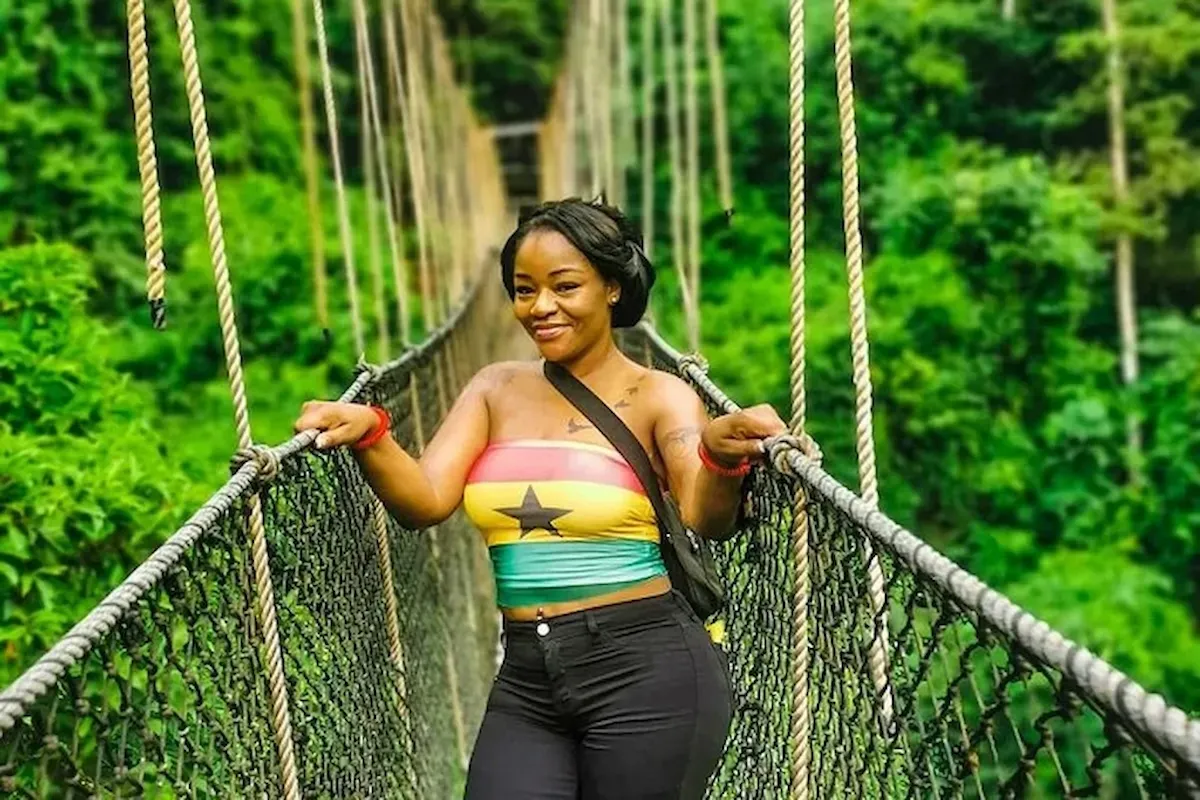 A traveler walking along the Kakum canopy walkway- BookAfrica Cape Coast Heritage experience.