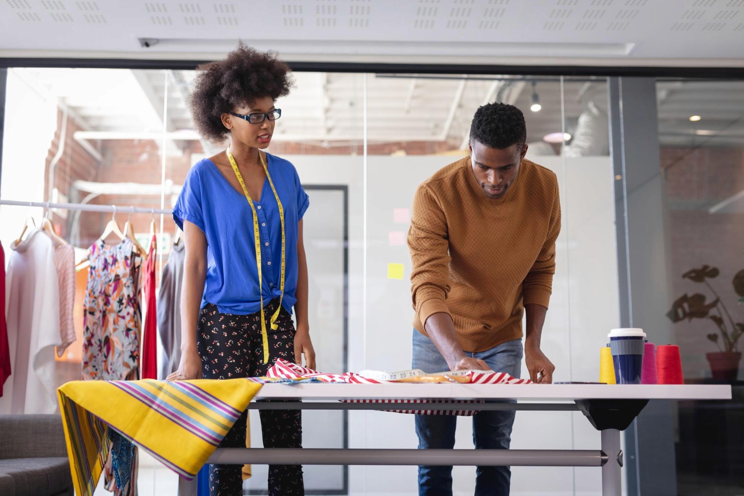 woman holding a phone and man looking at the phone. both are smiling