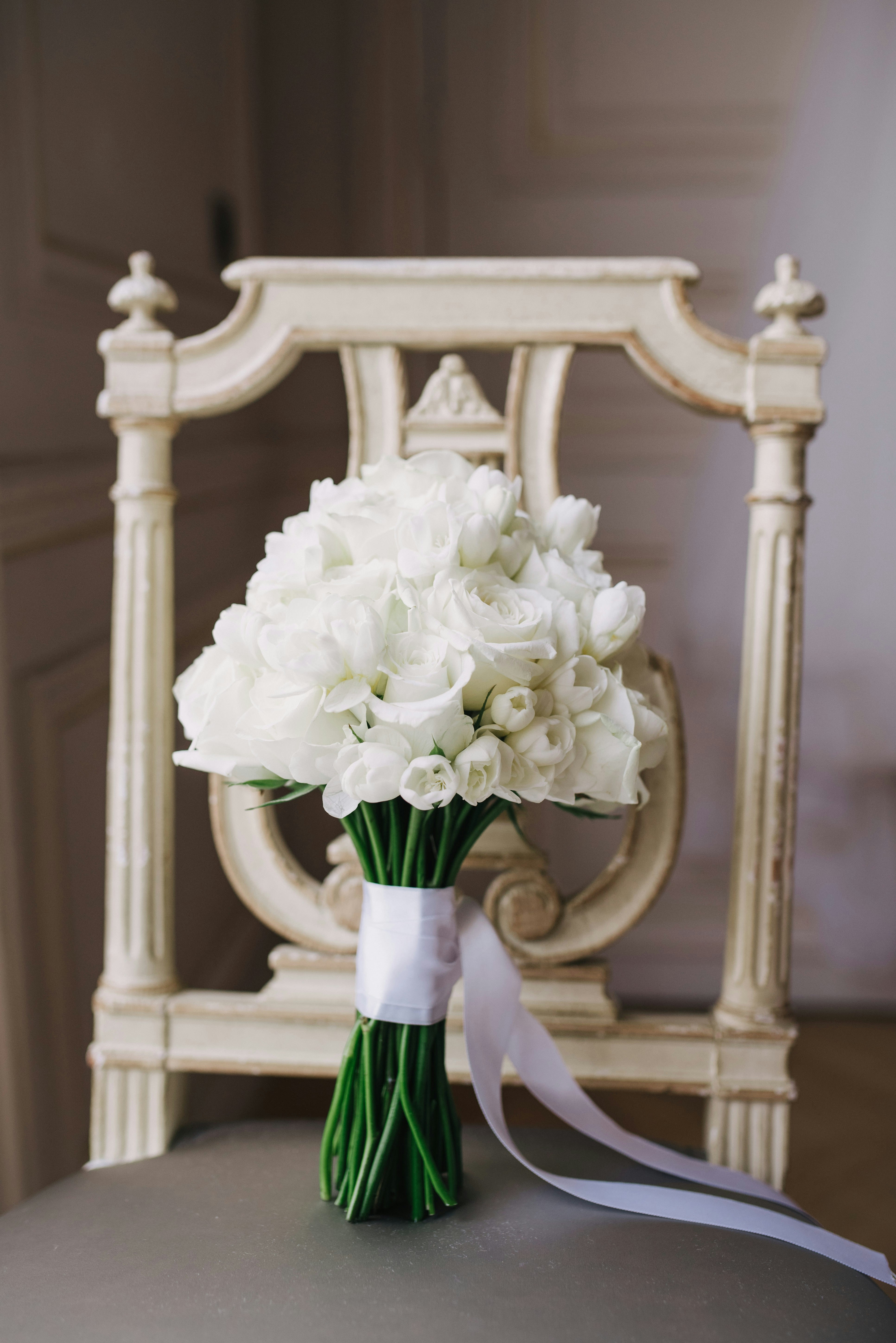 a bouquet of white flowers sitting on top of a table