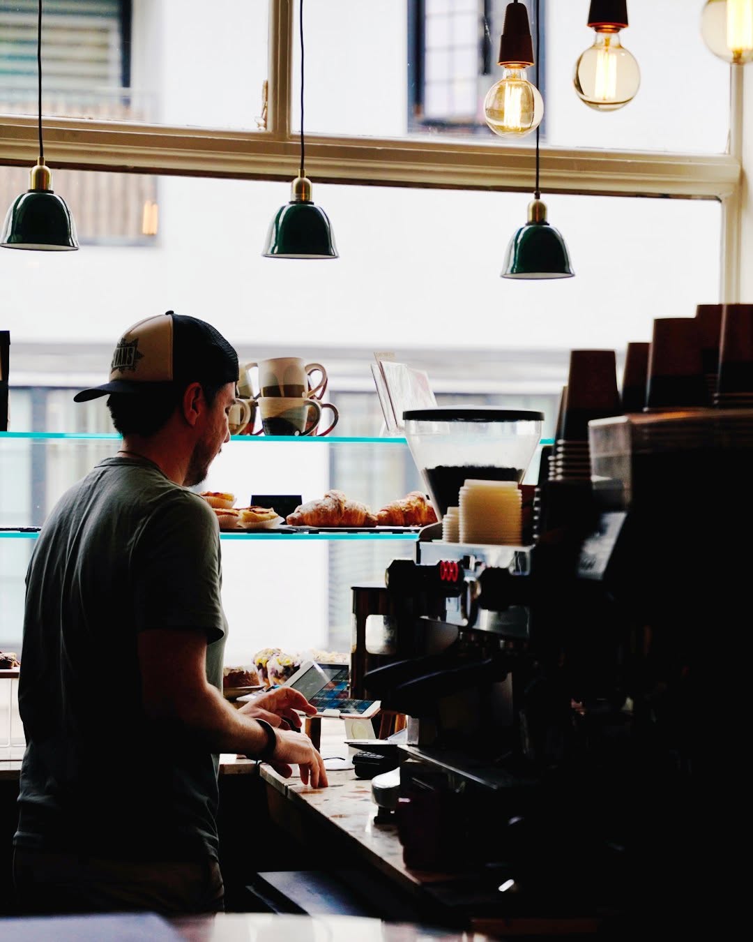 Barrista working behind desk at family coffee shop in Muswell Hill