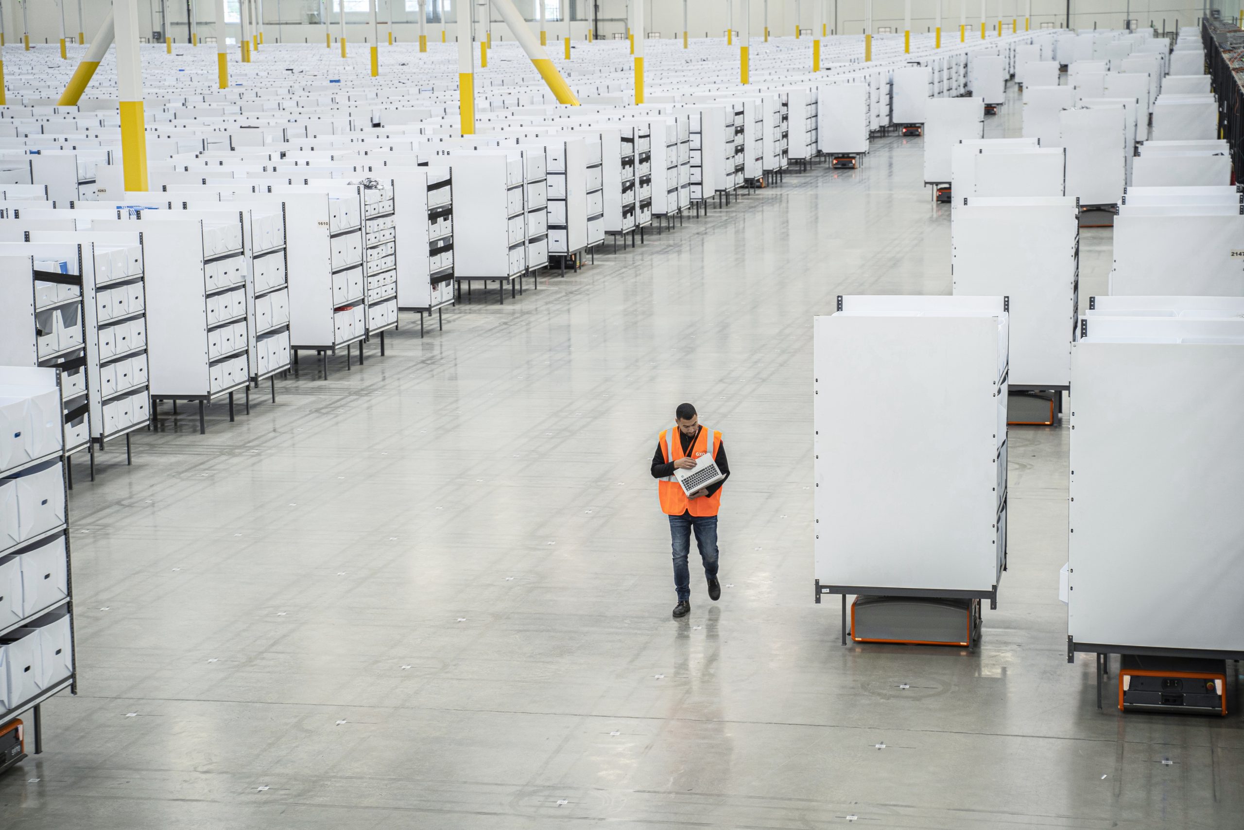 GXO logistics worker walking through warehouse