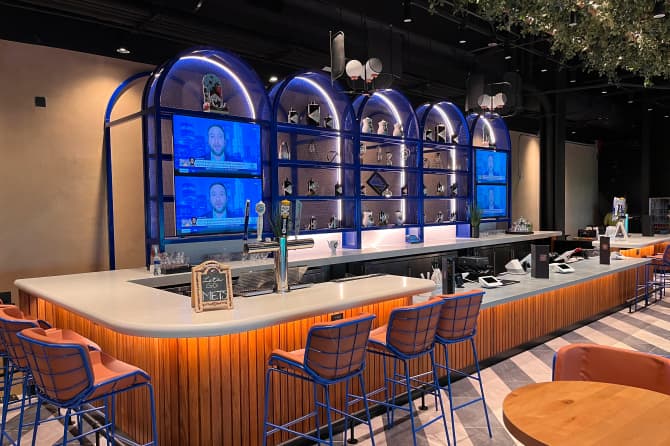 The bar showing its chairs and under lights