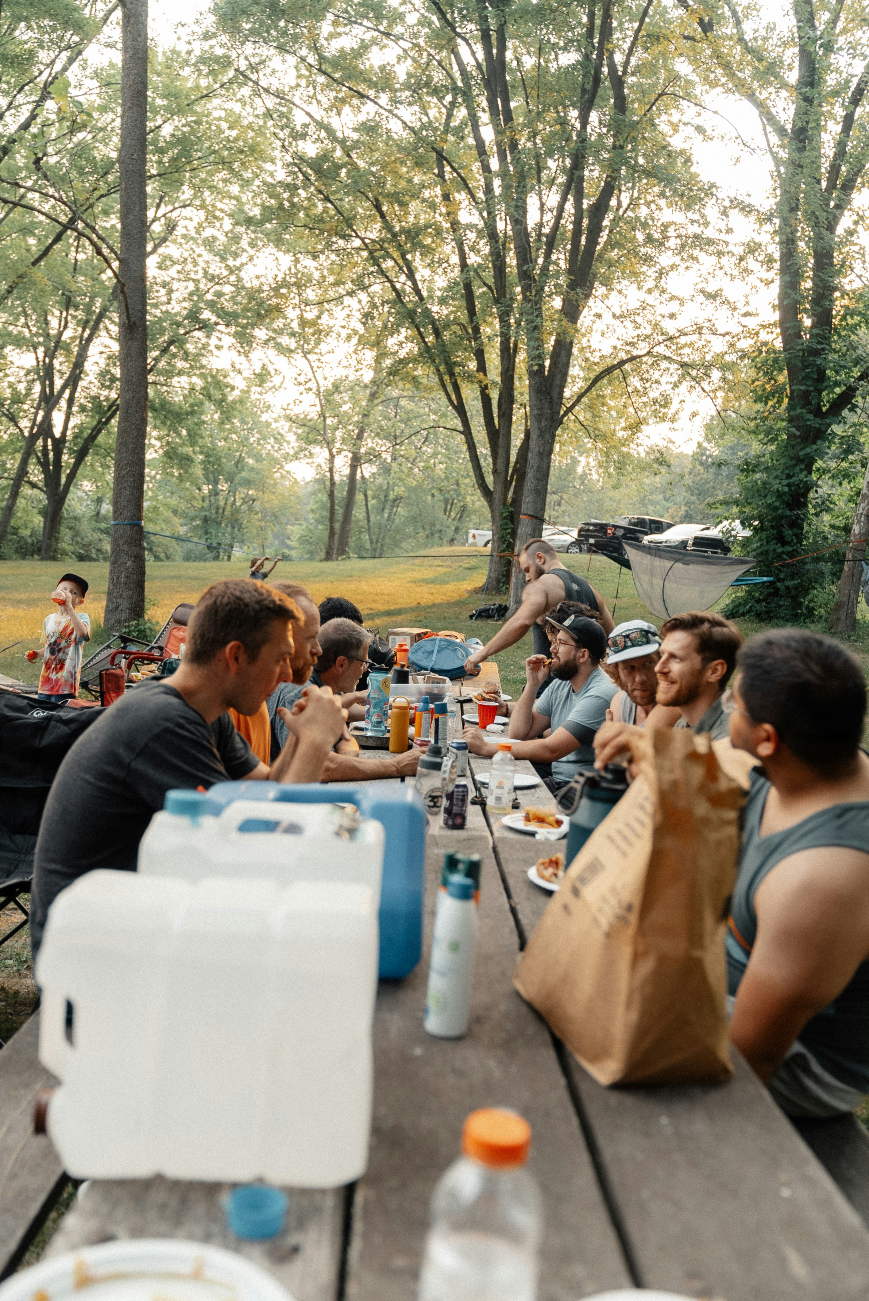 a group of people sitting at a picnic table