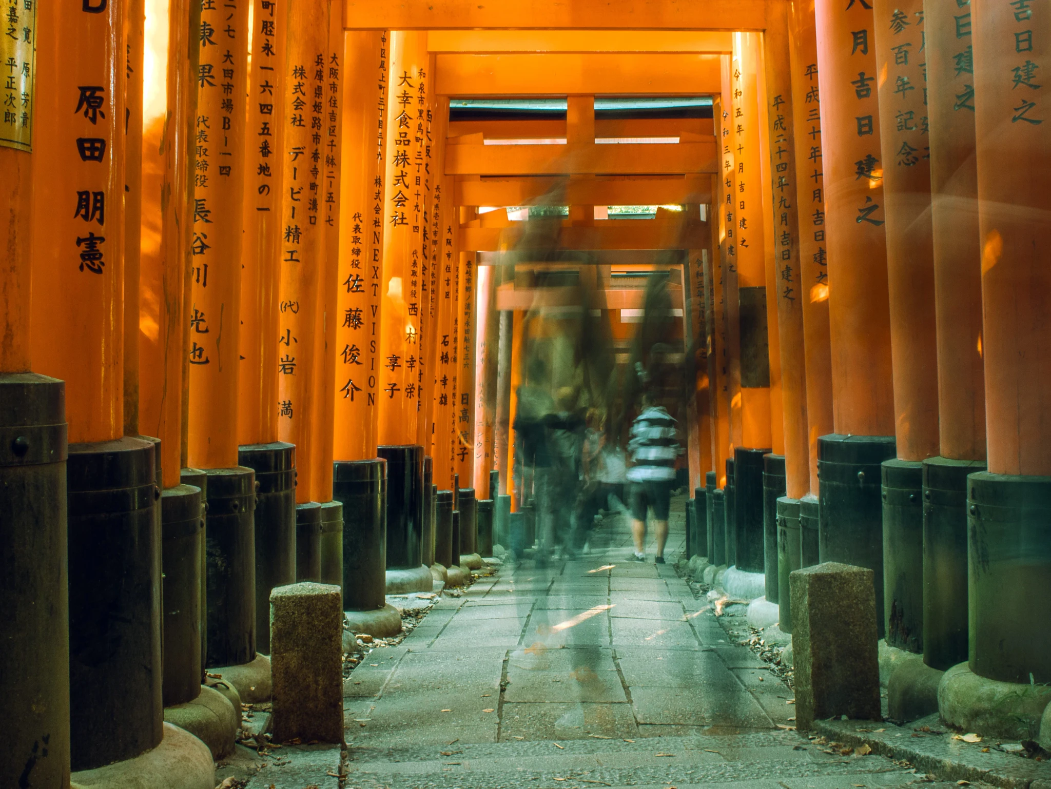 People walking through Fushimi Inari Taisha in Kyoto