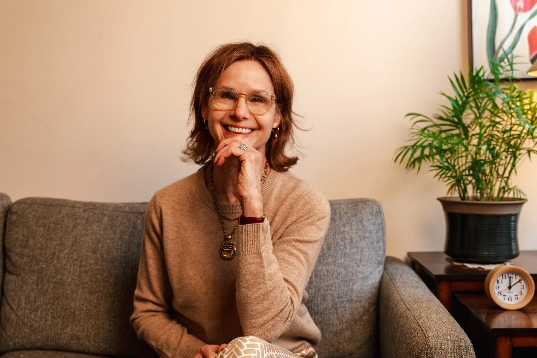 Wendy Cleary smiling while seated on a sofa