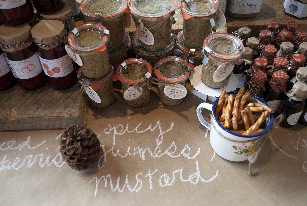 A photo with some jars that have different design labels on them.