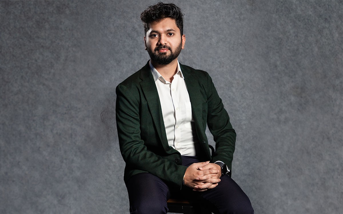 a man in a blue suit posing for a picture