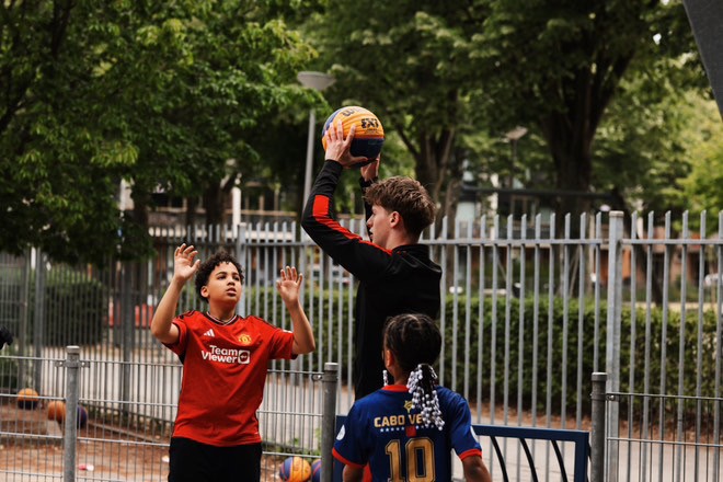 Two individuals are working out in a gym, focusing on dumbbells and strength training equipment.