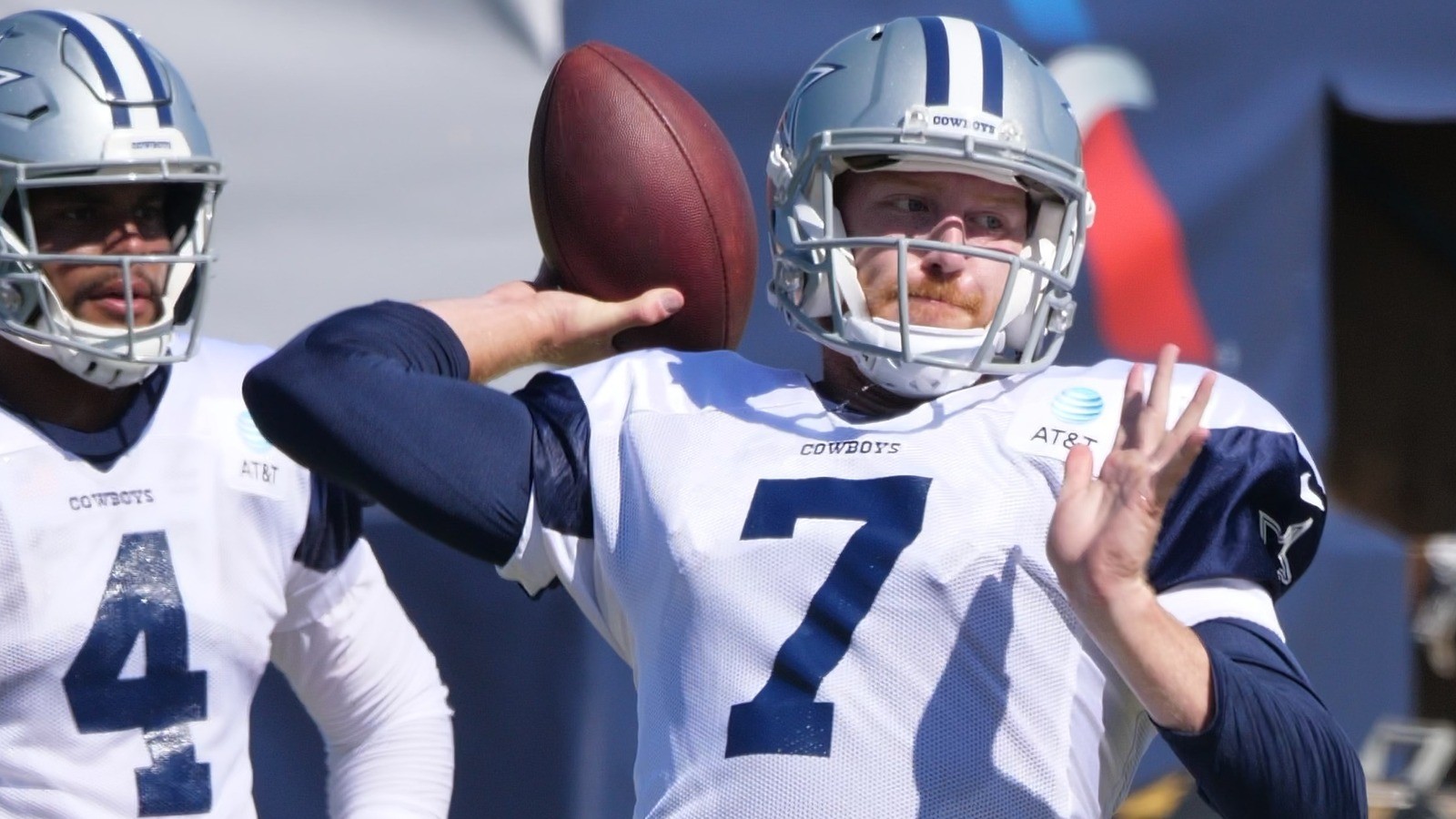 Cooper Rush in a Cowboys helmet mid-throw, face centered through the facemask