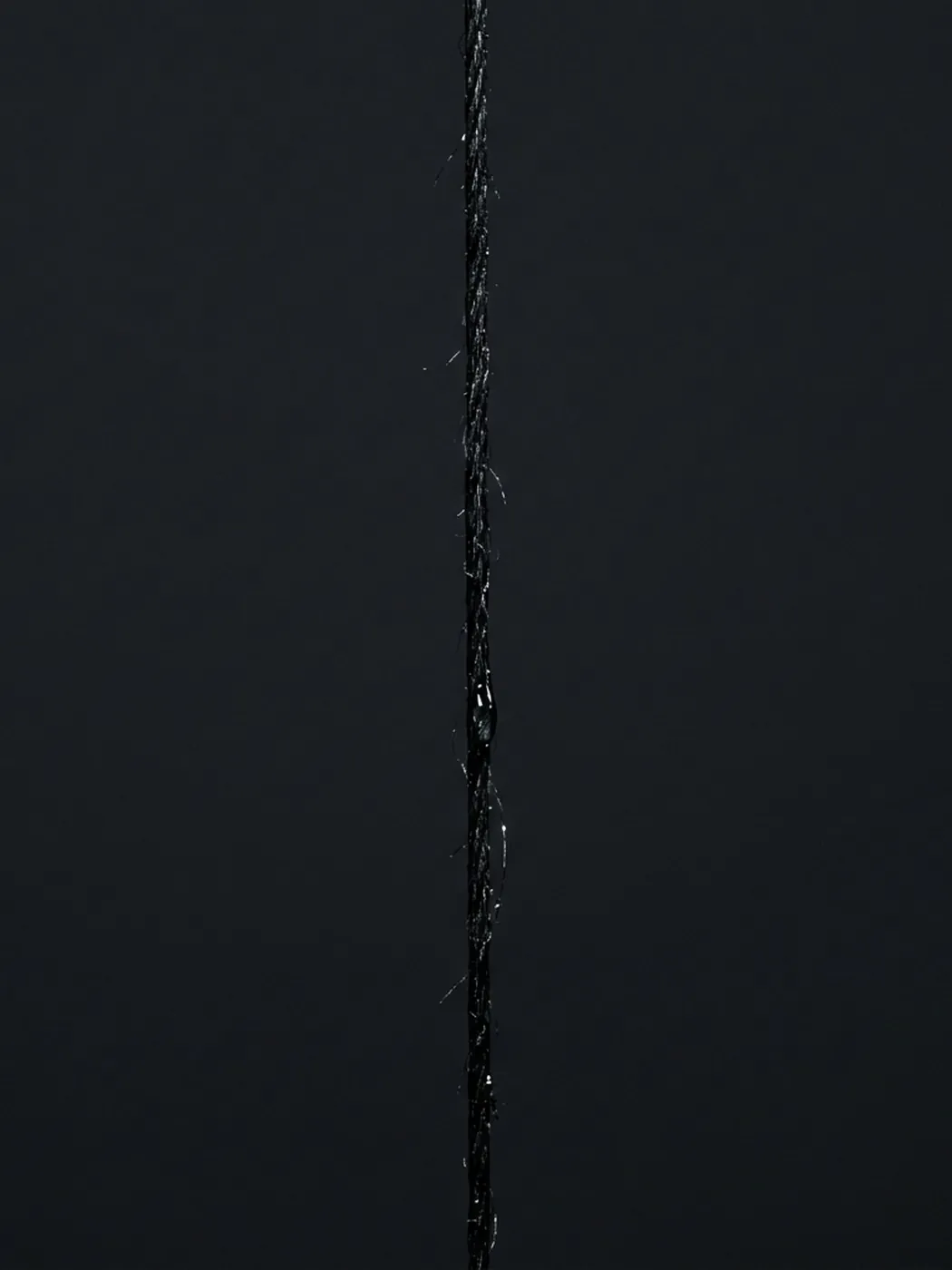 Black string against a dark background.