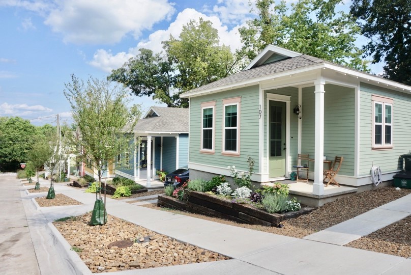 Pre-approved building programs a street lined with homes.