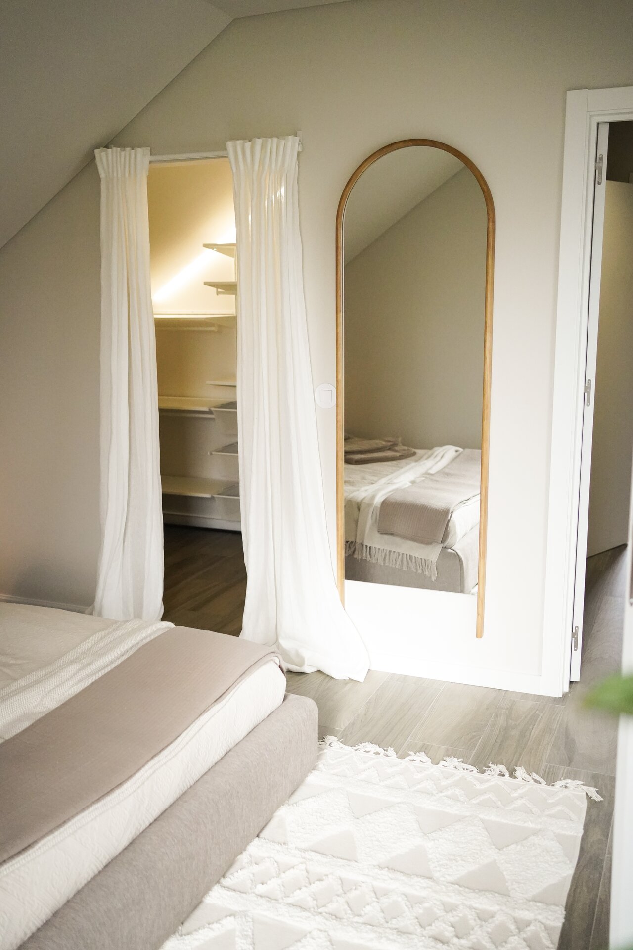 Bright bedroom entrance with mirror at Villa Flora